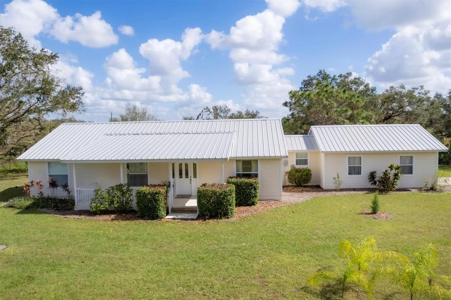 One or more photo(s) has been virtually staged. This thoughtfully maintained and move-in ready home is back on the market. This lovely home offers you the opportunity for the rural and country lifestyle.  Make this your mini-ranch or use the acreage to grow your own foods.  Don't miss your second chance to own this lovely home on 5 acres in Myakka that invites you to experience the perfect blend of country charm and privacy. From the pristine Hardi-plank exterior adorned with a metal roof, to the natural light of the interior, this 1,662 sq ft home is move in ready. The open kitchen adjoined with the cozy dining area and breakfast bar is the center of the home and leads out to a screened- in back porch where you can enjoy the view and relax.  Flooring is wood laminate throughout with ceramic tile in the both bathrooms.  This 3 bedroom, 2 bath home sits in the rear of the property and cannot be seen from the main road which allows for privacy. Natural Florida trees and plants as well as a small pond, cover the majority of the property.  Extremely clean, attached one car garage with pull down attic access that offers more storage compacity.  Property is zoned ag residential so build your barn or other outdoor buildings. Horses, cattle, other farm animals and pets are allowed. No HOA or deed restrictions.  Step inside to find warm, inviting interiors bathed in natural light, featuring classic design elements that blend seamlessly with thoughtful modern updates. The spacious living area flows effortlessly into a cozy dining space, perfect for intimate gatherings or entertaining friends and family. The kitchen boasts ample counter space, custom cabinetry, and quality appliances, making it as functional as it is beautiful.  Each bedroom offers a serene view, with large windows that frame stunning views of the surrounding landscape, ensuring a sense of calm and privacy. Outside, the expansive acreage is a paradise for nature lovers, complete with pathways that wind through wooded areas. There's also plenty of space to add a garden, create outdoor living areas, or simply enjoy the quiet beauty of the natural surroundings.  There is a small pond at the front of the property.
This property is truly a sanctuary, ideal for anyone seeking a peaceful lifestyle without sacrificing convenience, as it's located within easy reach of nearby amenities and major routes. Outisde, enjoy the natural beauty of Florida while "birding" from your screened, back lanai.  With every detail carefully curated and maintained, this charming home on private acreage offers a unique opportunity to embrace both charm and the great outdoors.   There is a 50' foot easement along the south boundary line for the neighbor to access their property.