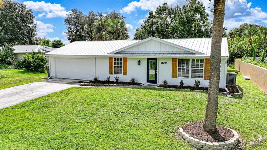 Beautiful, well-maintained 2-bedroom, 2-bathroom, 2-car garage home located in a quiet neighborhood. Why rent when you can own for less?  Checks every box on your search for a slice of paradise.  NOT IN A FLOOD ZONE.  Public water.  This home has been completely remodeled.  The gorgeous kitchen offers all new wood cabinets with soft-close drawers, stainless steel appliances, sparkling granite countertops.  This home has wood plank ceramic tile throughout.  NEW METAL ROOF. IMPACT WINDOWS.  NEW AIR CONDITIONER.  Over-sized 2-car garage with newer wind rated door.  Large lanai and backyard.  Conveniently located near I-75, shopping, restaurants, hospitals, and a short drive to Gulf Beaches. “Virtual Tour 1” to view the 3-D Tour and Floor Plan. "Video Tour 2" to view video tour.