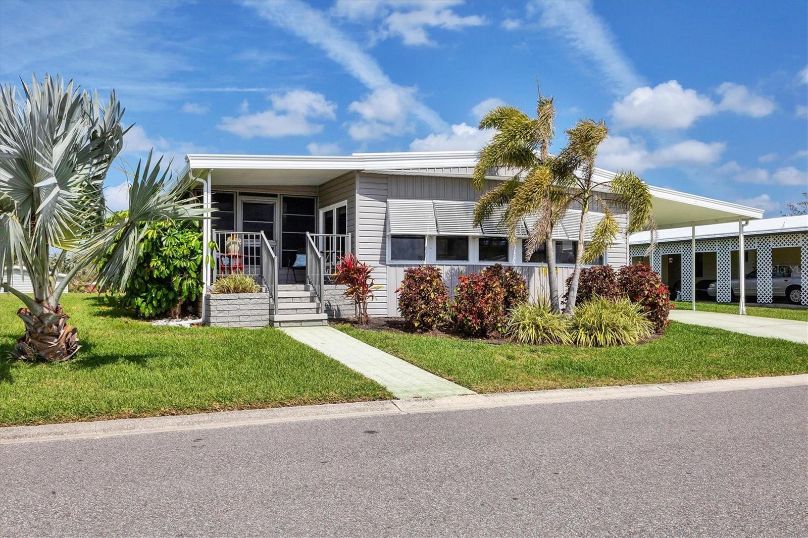 This home is ready for you to move in and enjoy! Welcome to Tidevue Estates, a land-owned 55+ community! This tastefully turnkey furnished home features an inviting open front porch and a lanai with an outdoor patio offering a serene view of Egret Lake. The open floor plan has a bright and spacious living room with a wall of windows. The Kitchen has been updated with laminate flooring, a tile backsplash, light cabinetry and plenty of counter space, including a breakfast counter. The spacious primary bedroom offers a lovely view of the green space and includes a master ensuite bathroom with updated laminate flooring, wainscoting, an updated vanity, and a walk-in shower. The AC unit is only three years old. Updated windows throughout. Additionally, there is a storage shed/laundry room, perfect for a workshop or art/craft area. You can also create an outdoor living room under the carport, with room to park your golf cart. Low HOA of only $600 annually. Pets are not permitted. Plenty of activities to keep you busy in this community. Take a water aerobics class in the solar-heated community pool or work on your tan. The community library has free WI-FI connection. Updated fitness center. Meet friends and make new ones for a game of indoor pickleball, bocce ball, or shuffleboard. Join the Golf League. Take a bike or golf cart ride to Veteran's park to watch the wildlife and sunset. Ellenton Premium Outlet Mall, restaurants, and medical facility's just minutes away. Easy access to I-75. Explore Sarasota and visit University Town Center Mall, St. Armand's Circle, Selby Botanical Gardens, and the Ringling Mansion & Museum. Not to mention a short drive to our beautiful Gulf Beaches. Don't miss this opportunity to own a beautiful home in Tidevue Estates!