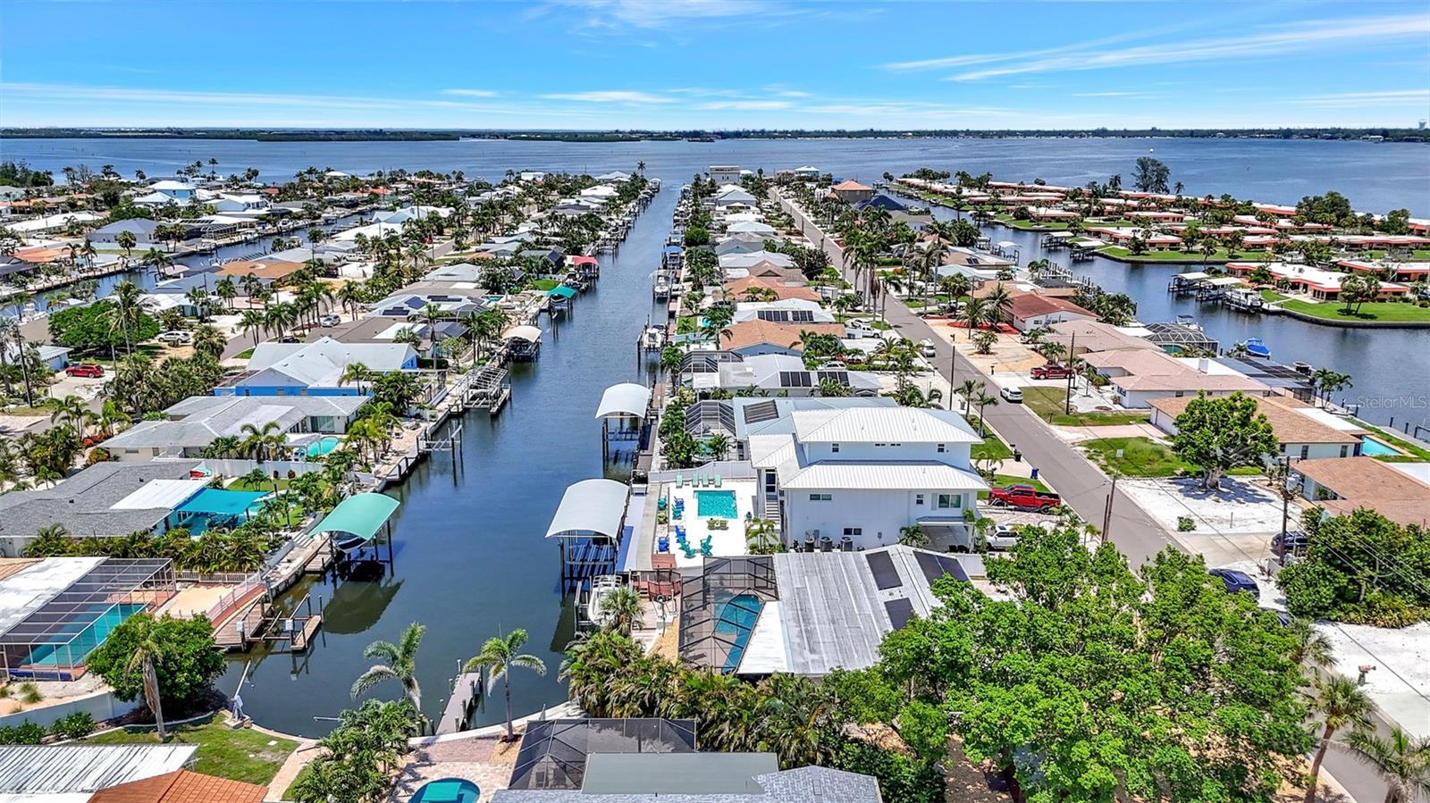 Discover the essence of Florida living in this stunning Canal Front swimming pool home. Step inside to an exquisite custom chef's kitchen featuring a large island, abundant workspace, all custom cabinets, quartz countertops, and newer appliances—including a cooktop with hood vent. The residence offers 3 spacious bedrooms and 3 full bathrooms, along with a generous bonus room complete with its own mini split air conditioner—ideal for a home theatre, personal yoga studio, or versatile workspace. Outside, enjoy boating from your backyard oasis, saltwater canal complete with a 10,000 lb boat lift and dock, where depths of 5–8 feet accommodate your aquatic adventures. Relax by the beautiful swimming pool with its enchanting waterfall overlooking the canal, or entertain guests on the expansive screened lanai with its large covered entertaining area. Additional highlights include a newer roof installed in 2020, solar panels from 2021 that help keep electric bills low, and a large, oversized corner lot with extra parking and a circle paver driveway. With stunning sunsets, great boating water, and close proximity to beaches and restaurants, this home truly embodies the ultimate Florida lifestyle—with the option of an HOA for added convenience.