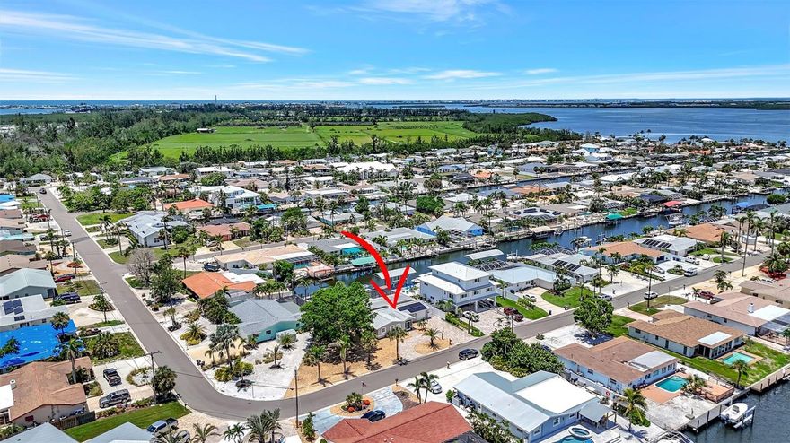 Discover the ultimate Florida waterfront lifestyle in this canal-front pool home located in the highly desirable San Remo Shores boating community with no bridges to the Gulf of Mexico. Great Vacation spot, close to the Beaches! This home did not flood and offers true boat-to-bay convenience with a private dock and 10,000 lb boat lift on saltwater canal waters ideal for serious boaters. Inside, you’ll find a stunning custom chef’s kitchen designed for both everyday living and entertaining, featuring a large center island, expansive prep space, custom cabinetry, quartz countertops, and newer high-end appliances including a cooktop with vented hood. The home offers three spacious bedrooms, three full bathrooms, and a large bonus room with its own mini-split air conditioning system, perfect for a home theater, office, gym, or flex space, or covert back onto a garage. Step outside to a private backyard retreat where a sparkling swimming pool with waterfall overlooks the canal, creating the perfect setting for relaxing or entertaining. The expansive screened lanai includes a large covered entertaining area, while the oversized corner lot provides exceptional privacy, extra parking, and a circular paver driveway. Additional features include a new air conditioner in 2025, a roof replaced in 2020, and owned solar panels installed in 2021 to help keep electric costs low. Enjoy breathtaking sunsets, excellent boating water, and convenient access to nearby beaches, dining, and shopping, all while enjoying the flexibility of an optional HOA. This waterfront home delivers comfort, functionality, and the boating lifestyle buyers are searching for in Bradenton.