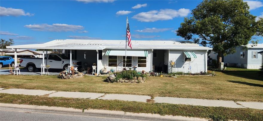 Beautiful, well kept 2 bedroom  2 bath double wide mobile home in desirable MH park.  Large living / dinning room combo.  Table for four in kitchen with lots of cupboards.  Wood flooring throughout, Central AC with wall unit in Florida room.  Double carport, extensive flower gardens, separate laundry room with plenty of space for workshop. Owner will consider financing.