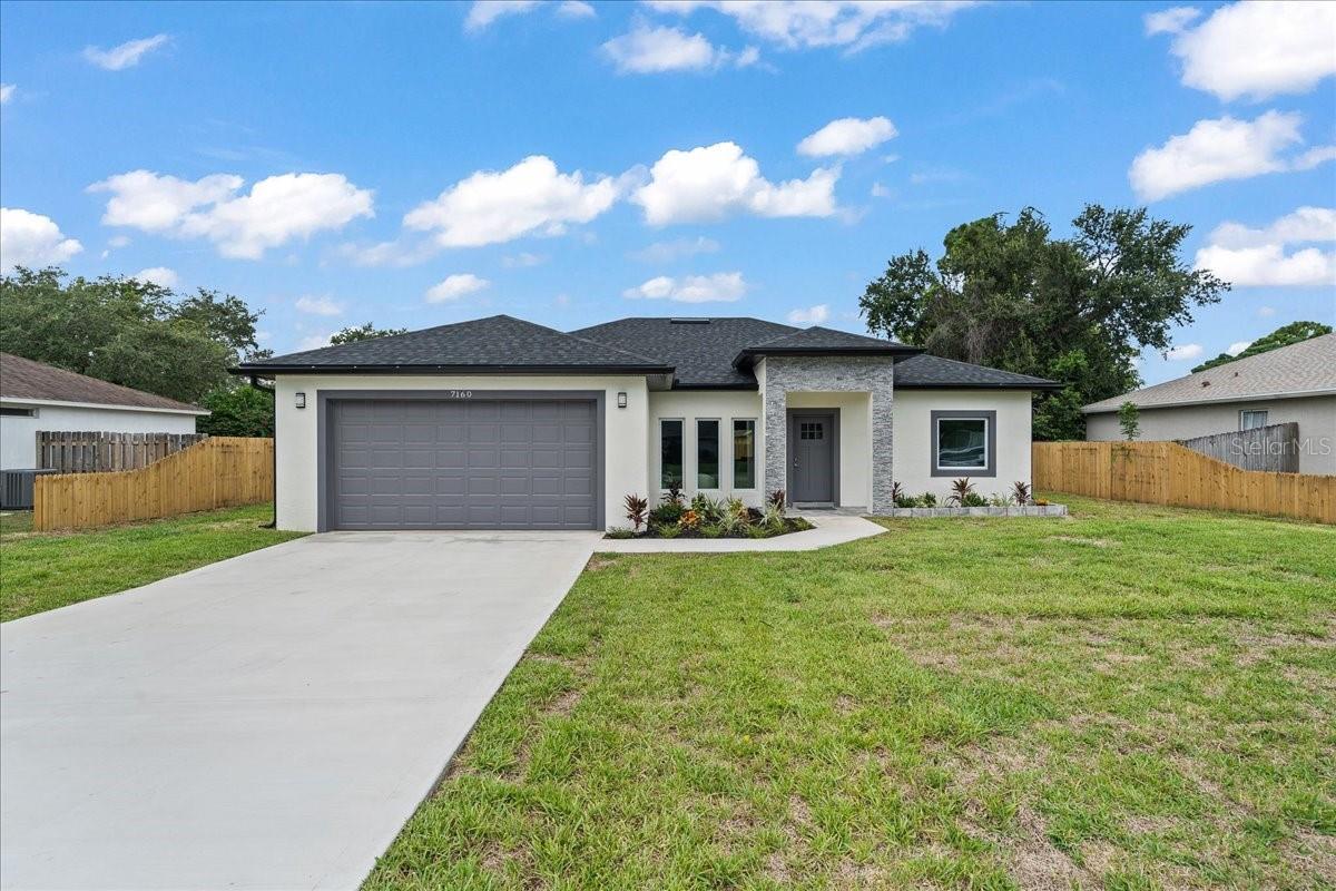 Stunning New Construction - 4 Beds, 2.5 Baths, Impact Windows! This brand-new home blends style, comfort, and quality upgrades throughout. Enjoy tall ceilings, impact windows, and an open layout perfect for modern living. The kitchen shines with quartz countertops, stainless steel appliances, and a large breakfast bar that opens to the living and dining areas — all with views of the fully fenced backyard. The split floor plan offers privacy, featuring a serene primary suite with double closets, a spa-like bath, and sliding doors to a tiled lanai. Bedroom 2 sits privately across the home — ideal for guests or a home office — while Bedrooms 3 and 4 are just down the hall. Why pay extra for upgrades? This home has them all included. Don't miss your chance — schedule a showing today!