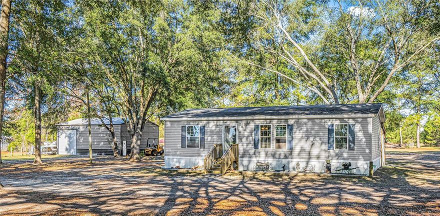 Escape to peaceful country living with this well-maintained 3-bedroom, 2 bath home situated on 8.6 beautiful acres in Bell, FL. This spacious property offers room to spread out and enjoy the quiet rural lifestyle while still being close to town conveniences. The home features a covered back porch perfect for relaxing and taking in the surrounding nature. Two outbuildings provide endless possibilities—one is a 12x30 building equipped with AC and electric, ideal for a workshop, hobby space, or storage. The second is a large 30x40 metal building with 100-amp panels already set up inside, offering plenty of power for equipment, tools, or future projects. For added convenience, there is also a 50-amp RV hookup complete with a connection to the septic system. The property is partially fenced, making it suitable for animals or additional outdoor uses. Located just about 2 miles from Log Landing Boat Ramp, this home gives you quick access to the pristine Suwannee River, known for boating, fishing, kayaking, and swimming. The Bell area is surrounded by natural springs, state parks, and wildlife, offering endless opportunities for outdoor recreation. Enjoy small-town charm with nearby local shops, restaurants, and highly rated Gilchrist County schools, all while living in a peaceful, scenic setting.