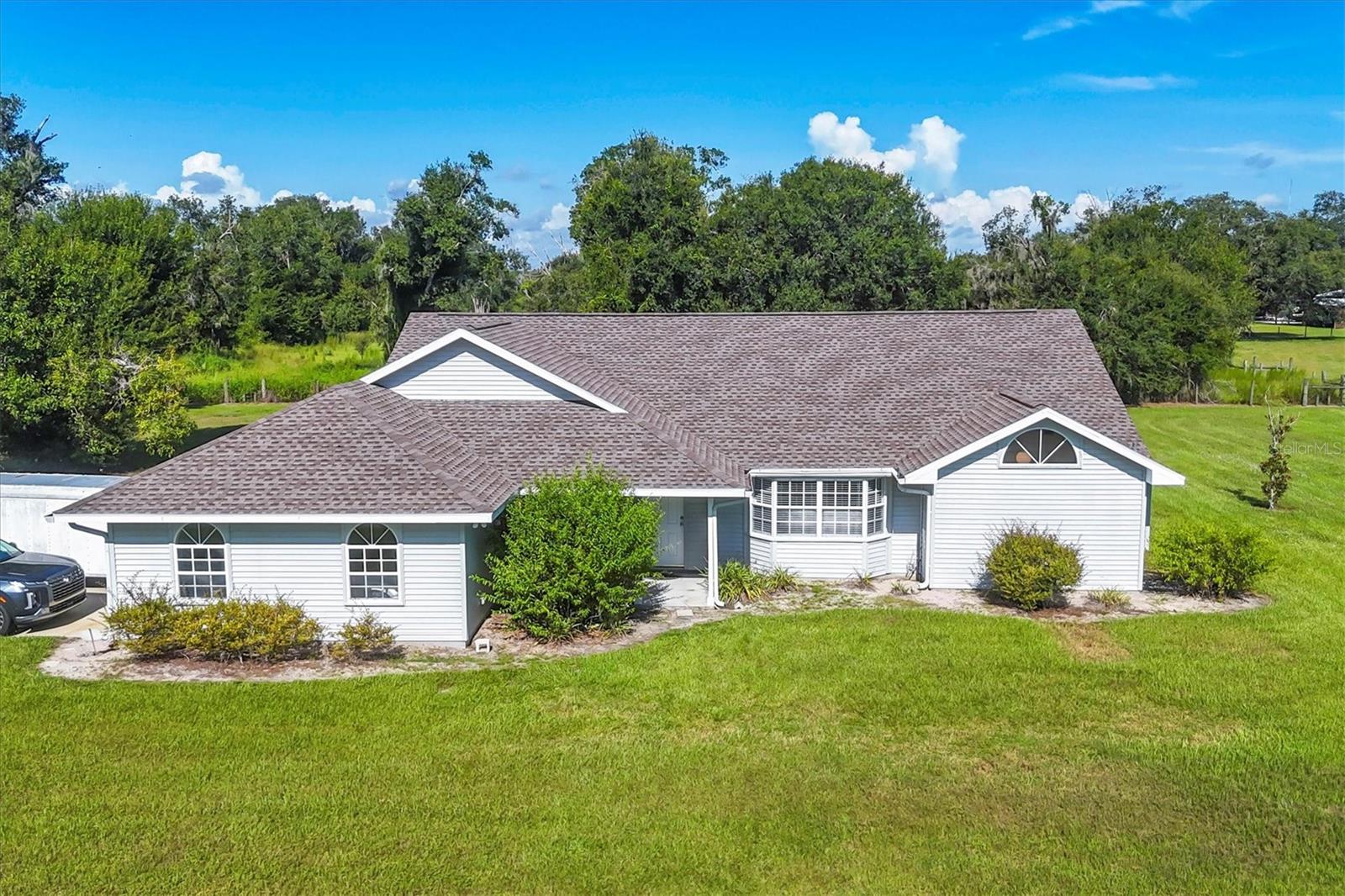 Peaceful Country Living with Room to Roam
Welcome to 3193 SW County Rd 661 in Arcadia, Florida. This well-built 3 bedroom, 2 bathroom home sits on 5 beautiful acres filled with mature oak trees and plenty of open space. Built by respected local contractor Barry Raineri, this home has a solid reputation for quality construction.
Inside, you'll find a spacious layout, oversized 2-car garage, and a flexible third bedroom with built-in shelving that works well as a home office or hobby space. The home has been well cared for and offers a great opportunity to add your own personal style. A new roof was installed in 2023 and the A/C system was updated in 2021.
The property is cross-fenced with water spigots in place, making it ready for animals or outdoor projects. A small barn on-site is currently used for storage and is large enough to hold equipment or even a boat.
Just about 15 minutes from I-75, this property offers peaceful country surroundings while still being within a reasonable drive to the coast or nearby towns. Other homes in the area on similar acreage are currently listed at over $700,000, making this an excellent opportunity for value and future potential.
* No HOA
* New roof in 2023 and A/C in 2021
* Cross-fenced with water access for animals or gardens
* Storage barn currently houses a boat
Come see how this versatile property can fit your needs and lifestyle.