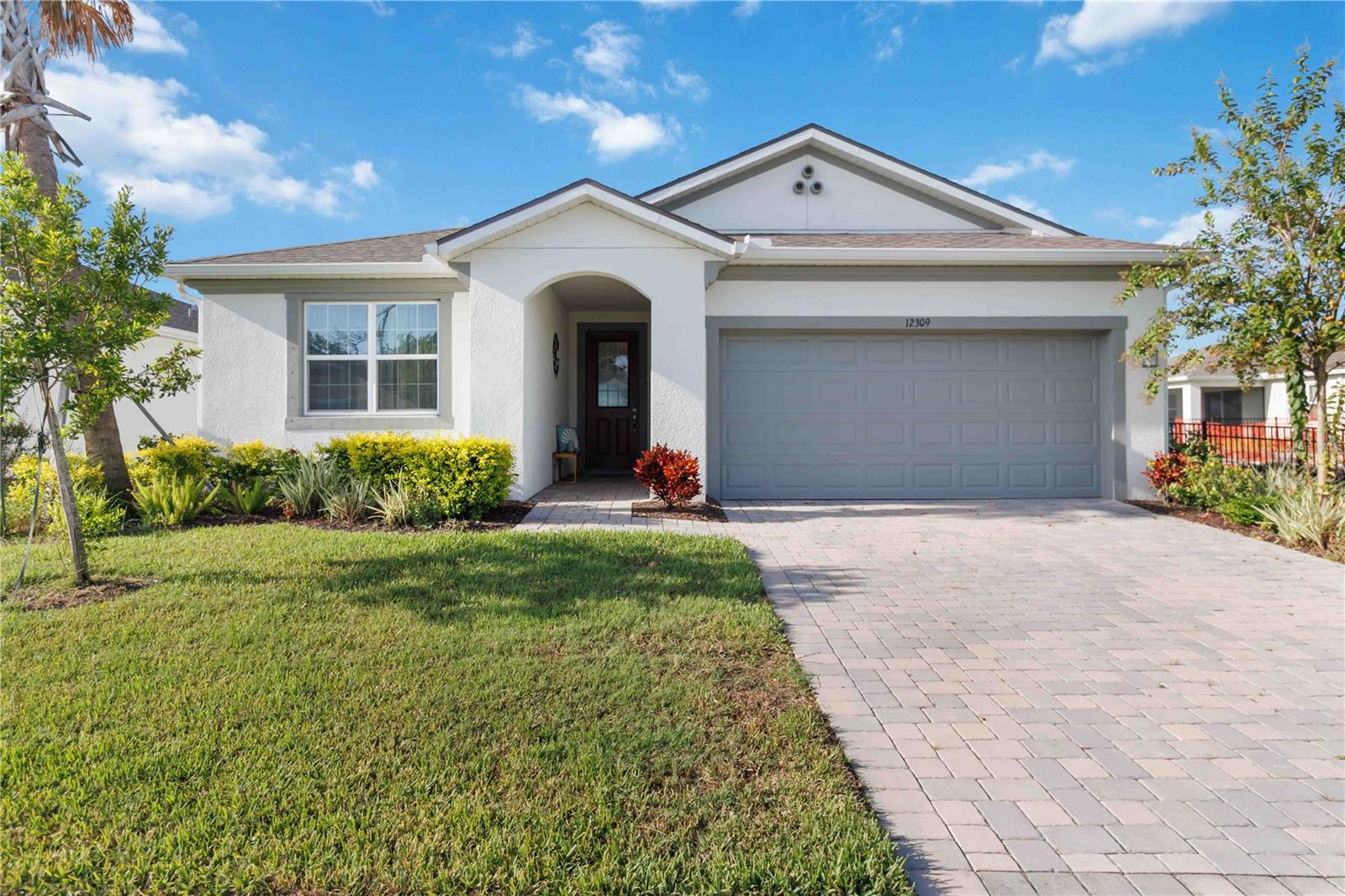 Welcome to this like-new 2024-built Mattamy Homes Glades model in the heart of Parrish—just a step away from paradise in the gated community of Windwater. This home offers the rare opportunity to assume the seller’s low-interest loan (subject to lender approval). With 3 bedrooms, 2 baths, and a flex room, you'll enjoy over 2,000 square feet of stylish living space with peaceful pond views and a fully fenced backyard. Inside features an open layout with wood-look tile in the main areas, a spacious great room, and a gourmet kitchen with quartz countertops, stainless appliances, 42-inch cabinets, a large island, and walk-in pantry. The primary suite includes dual vanities, an oversized shower, private water closet, and walk-in closet. Two additional bedrooms and a flex room which cold be a great space for guests, a home office, or playroom. Enjoy outdoor living on the screened and covered lanai overlooking the pond—plumbed and ready for your future outdoor kitchen. The fenced backyard offers privacy with room to add a pool.This home is HERS-rated for energy efficiency, helping reduce monthly utility costs. Additional features include a full laundry room, hurricane shutters, in-wall pest system, and a two-car garage. Windwater offers resort-style amenities including a zero-entry pool, clubhouse, playground, and dog park—all with a low monthly HOA. Conveniently located near top-rated schools, shopping, dining, and major roadways. Just a short drive to world-class beaches, dining and shopping at UTC and downtown Sarasota, and within easy reach of SRQ and TPA airports—this home truly blends lifestyle, value, and location.