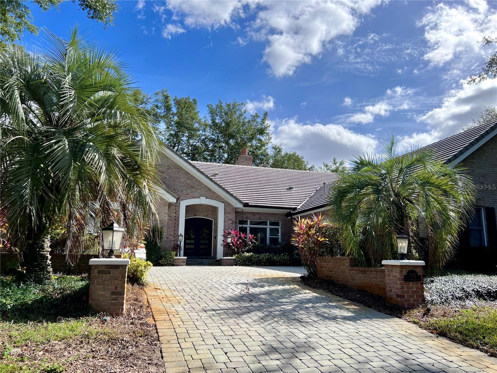 Available for immediate occupancy. This beautiful, traditional five-bedroom pool home is on a quiet cul-de-sac in Isleworth, Windermere. The traditional brick exterior, grand French doors, and warm mahogany wood floors invite friends and family home. Enjoy views of majestic oaks, the 7th fairway, and Lake Bessie on this half-acre lot. This two-story home is perfect for entertaining and easy to maintain. Fall in love with luxury details from the updated kitchen, wrought-iron staircase, wood accent beams, and luxurious bathrooms featuring Toto toilets and floor-to-ceiling Scabos travertine tile. This home features an open floor plan with a spacious kitchen and dinette overlooking the patio, heated pool, and majestic oak trees. The sitting and family rooms share a wood-burning double-sided fireplace and large picture windows with views of mature landscaping and the 7th fairway. Enjoy family meals and hosting special events in the formal dining room, and guests can relax and connect in the kitchen at the granite countertop bar and oversized kitchen island. The kitchen is the heart of your home, and get ready to fall in love with the updated cabinetry, Viking gas range, three ovens, and stainless fridge. Cooking is a breeze with all the prep space on the oversized island and ample storage. Double French doors from the family room provide easy access to the covered, screen-enclosed patio and summer kitchen for al fresco dining, with access to a convenient private patio powder room. Enjoy magical evenings under the stars from the open-air travertine courtyard, leading to the heated pool and views of Lake Bessie. Parking is never an issue, thanks to the three-car garage and oversized paver driveway that can easily accommodate additional parking for six. A separate membership is required to access the amenities of the Isleworth Golf and Country Club. Schedule your appointment today to join the Isleworth community and lifestyle.