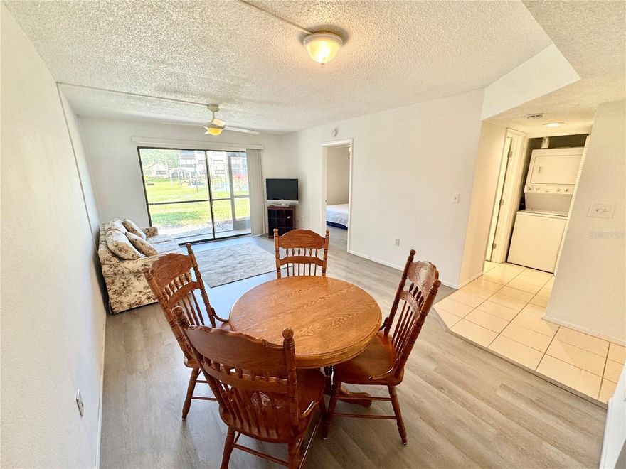 Welcome to Sandhill Pines, your new home in the heart of Port Charlotte! Nestled within a vibrant 55+ community, this ground floor corner unit offers a rare opportunity for both convenience and tranquility. As you step inside, you're greeted by an inviting open floor plan that seamlessly combines the living and dining areas, creating a spacious and airy atmosphere perfect for entertaining or relaxing. BRAND NEW LUXURY VINYL FLOORING in the living room and the bedrooms that was just recently done. The condo boasts modern comforts, including a newer water heater and A/C system, ensuring year-round comfort. Convenience is key with a stackable washer and dryer tucked away inside the unit, making laundry days a breeze. Step outside onto your private screened balcony, where you can unwind and enjoy the serene surroundings. With a storage closet included, you'll have ample space to stow away your belongings. For those who enjoy an active lifestyle, the community offers amenities such as a tennis court and a refreshing pool. Nature enthusiasts will appreciate the beautiful pond situated just beyond the condo, providing a peaceful backdrop to your daily routine. While the seller has left the living room and bedrooms bare, they've provided a blank canvas for you to personalize your space with the flooring of your choice, allowing you to make it truly your own. Location couldn't be better, with easy access to I-75 and just a short drive to Englewood Beach and Boca Grande Beach, where you can soak up the sun and enjoy the coastal lifestyle. Additionally, convenience is at your doorstep, with Winn Dixie, Bealls, and a variety of restaurants and shops right around the corner. Don't miss out on the opportunity to call this Sandhill Pines condo your own. Schedule your showing today and start envisioning your new chapter in this wonderful community.