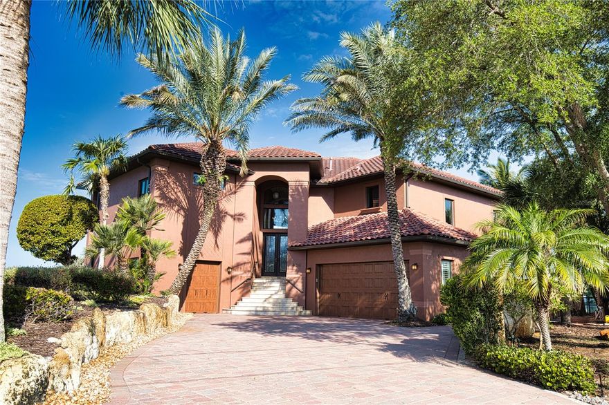 **Welcome to 420 Palmetto Crescent – A Luxurious Waterfront Oasis** Step into a realm of unparalleled elegance and breathtaking waterfront views at this custom-built masterpiece by Beechwood Builders. Nestled in the serene Nokomis, Florida, this stunning residence boasts 145 feet of private bay frontage, offering direct access to the Gulf of America just minutes away—perfect for boating enthusiasts. This exquisite 3-bedroom, 2.5-bath home is designed for both relaxation and entertainment. The spacious garage accommodates up to 7 cars and includes a workshop area. Dive into the luxurious saltwater pool or unwind in the spa, by an inviting outdoor kitchen, featuring a new gas grill, ideal for alfresco dining. The beautifully landscaped property features a meticulously laid paver brick driveway, as well as, pavers surrounding the pool and covered lanai. Low-maintenance artificial turf eliminates the need for mowing. At the heart of the home lies a chef’s kitchen, complete with top-of-the-line Jenn- Air appliances. Elegant cherry wood cabinets and doors throughout add a warm touch, and designer pendant lights create an inviting atmosphere over the expansive island. The grandeur continues in the great room, which features a double bump-up ceiling soaring to 14 feet, adorned with sophisticated crown molding and a wet bar complete with a beverage cooler.  Enjoy seamless transitions from the living and dining areas to the balcony, where you can revel in serene views overlooking the pool, spa, and picturesque Lyons Bay. Centrally located, this luxurious residence is just a stone's throw from shopping, gourmet restaurants, stunning beaches, and the charming Venice Island. Experience the lifestyle you have always dreamed of—schedule your private showing today and make 420 Palmetto Crescent your luxurious waterfront sanctuary.