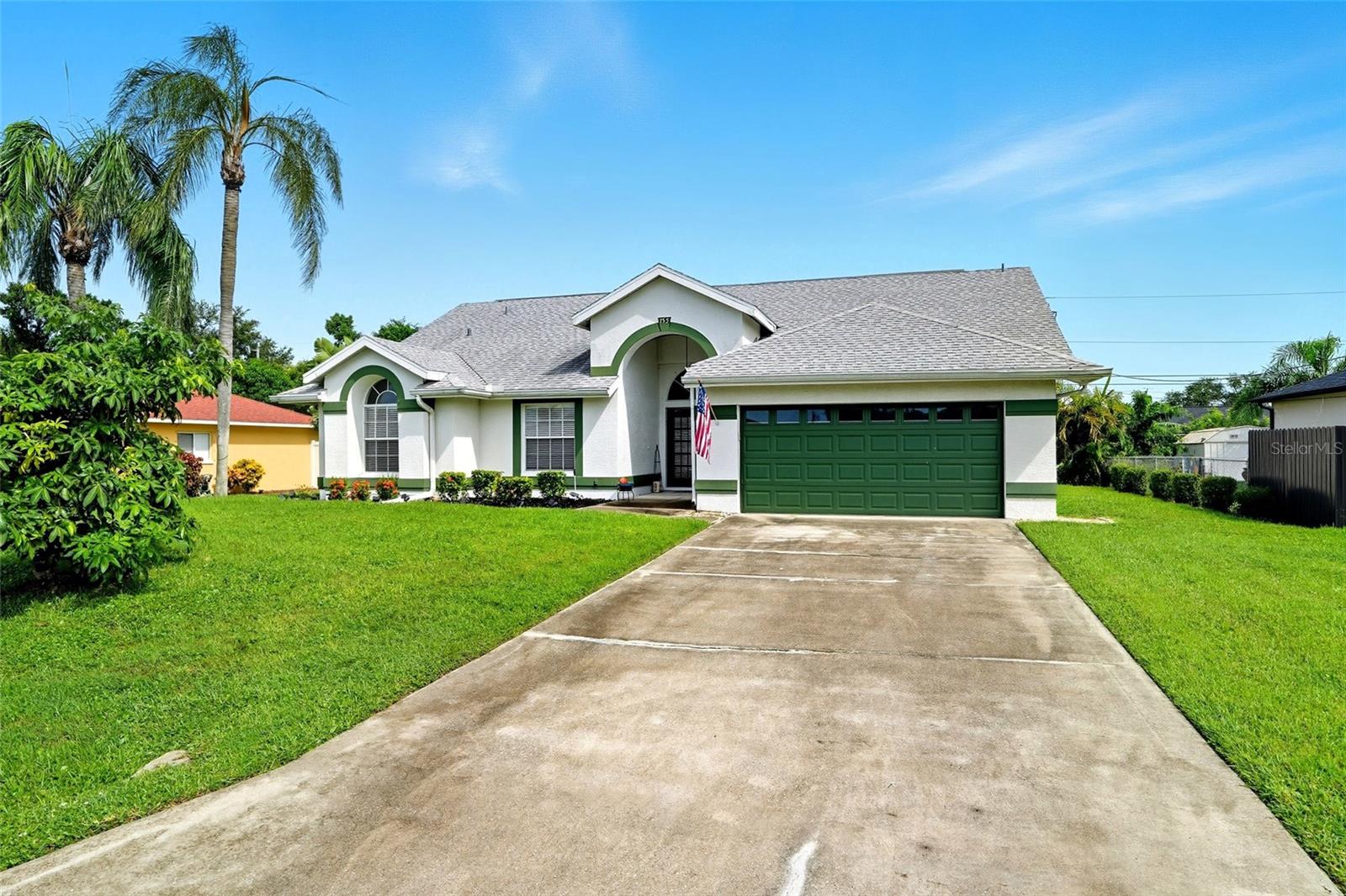 Welcome to this move in ready home. As you enter the house, you will notice the spacious great room with cathedral ceilings and patio doors to access the lanai. The kitchen has stainless steel appliances, a breakfast counter and is open to the dining and great room making it a great place to share time with your family or to entertain. Relax in your master bedroom that includes a walk-in closet and ensuite bath. The master bathroom has dual sinks, a tub/shower, a separate walk-in shower and a private toilet. The two guest bedrooms have ceiling fans, closets with organizer and a guest bathroom nearby. Enjoy time in the lanai that is covered and screened in allowing you to be out there any time of the day rain or shine. There is a sprinkler system to help keep your yard looking green. The backyard has a tropical feel with the palms lining most of the back of the property. A new AC was installed in 2024 and the roof was replaced in 2018.