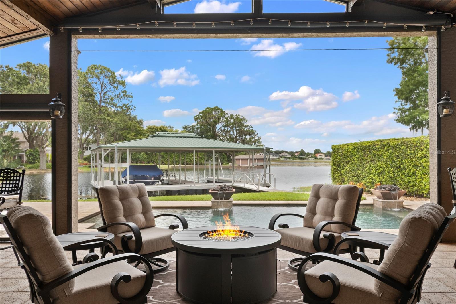 Discover the perfect blend of luxury, comfort, and outdoor living on the highly sought-after Lake Down of the Windermere Chain of Lakes. This beautifully updated 4-bedroom, 3-bathroom home offers the quintessential Florida lifestyle, with serene water views and exceptional amenities inside and out.
The heart of the property is its extra-large private dock, complete with two covered boat slips, perched on the shimmering waters of Lake Down. Whether you’re boating, fishing, or simply enjoying the sunset, this is lakefront living at its finest.
Step outside to the expansive back patio and pool area, designed for entertaining and relaxing alike. A summer kitchen, wood-burning fireplace, and retractable screens create an inviting space to enjoy year-round, while the sparkling pool and seawall add to the home’s functionality and charm.
Inside, you’ll find a thoughtfully updated interior with a spacious kitchen, modern finishes throughout, and a comfortable, flowing floor plan. The long driveway offers plenty of parking for family and guests, while mature landscaping adds privacy and curb appeal.
Don’t miss this rare opportunity to own an updated home on one of Windermere’s most coveted lakes--at an attainable price--with everything you need to make every day feel like a vacation.
