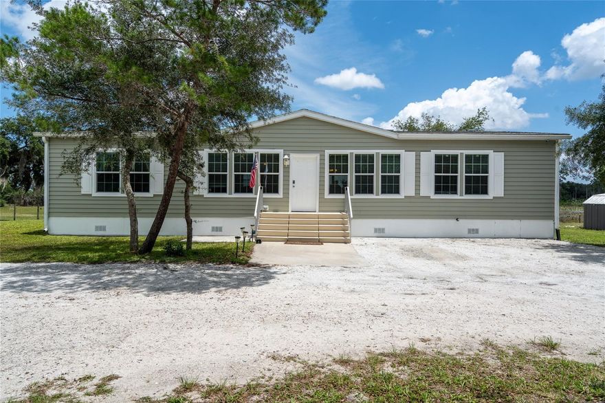 Rare opportunity to own over 10 acres of lakefront property in the heart of Deltona! This beautifully maintained 3-bedroom, 2-bath MODULAR HOME offers the perfect blend of privacy, functionality, and country living while still being centrally located near shopping, dining, and major roadways.
Surrounded by nature with a preserve directly across the street, this one-of-a-kind property is ideal for horse lovers, outdoor enthusiasts, or anyone looking for space to spread out. The property features a 36x36 garage/barn complete with 2 horse stables, tack room, and cross ties, along with partial fencing and a secure electric gate for added privacy and convenience.
Inside, the home showcases an open spacious floor plan, upscale finishes throughout including crown molding, luxury vinyl flooring, tray ceilings in the dining and primary bedroom, and oversized heavy-duty glass sliders that fill the home with natural light. Every bedroom includes spacious walk-in closets, while the oversized kitchen island creates the perfect gathering space for entertaining. The kitchen also features an oversized refrigerator and freezer, offering exceptional storage and functionality.
Enjoy peaceful mornings or relaxing evenings on the large 12x30 screened porch overlooking the expansive property and lakefront setting. Additional features include an indoor laundry room, water softener system, private well, and plenty of room for boats, RVs, animals, or future expansion.
Properties of this size and location rarely become available in Deltona — don’t miss your chance to own this unique lakefront retreat with endless possibilities!