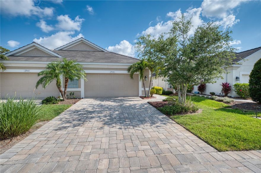 Welcome to effortless Florida living in the highly sought-after University Village—a gated, pet-friendly community known for its pristine landscaping, low HOA fees and NO CDD or Flood Zone! This beautifully maintained 2-bedroom, 2-bath paired villa offers the perfect blend of privacy, style, and convenience—just minutes from Siesta Key’s white-sand beaches, UTC Mall, the exciting new Mote Aquarium, and all that Sarasota has to offer.

You're welcomed through a large screened front entry to discover an airy open-concept floor plan. The spacious great room flows seamlessly into a well-appointed kitchen with solid wood cabinetry, granite countertops, custom pull-out shelving, a center island, and closet pantry—perfect for entertaining or everyday living.  PLANTATION SHUTTERS throughout.

Enjoy indoor-outdoor living at its best with an extended oversized lanai, overlooking a peaceful preserve for ultimate privacy. It’s even pre-plumbed for a gas outdoor kitchen—ideal for alfresco dining and relaxing in your own tropical oasis.

The generously sized primary suite is a true retreat, featuring two large walk-in closets and a luxurious en-suite bath with dual vanities, a walk-in shower, and private water closet. A surprisingly spacious garage includes built-in storage cabinetry, and a pavered driveway adds charm and function.

Recent updates include a new A/C system (2024). Residents of University Village enjoy top-notch amenities including a resort-style pool & spa and a community dog park—your furry friends will love it here too!

Whether you're searching for a full-time residence or seasonal escape, this villa offers the very best of maintenance-free Florida living. Don't miss your opportunity to call University Village home—schedule your private showing today and make your FL Dream come True!