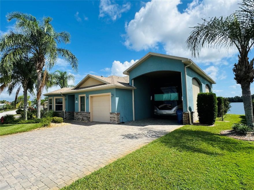 Stunning Lakefront Home in Mt. Olive Shores North!  Located in one of the most desirable 55+ Class A Motorcoach communities, this beautifully updated 3 bed / 2 bath single-story Goldsmith-built home sits on 85 feet of waterfront with room to add a pool.  Enjoy breathtaking views of Clearwater Lake - a private 78-acre lake perfect for boating and fishing right from your screened lanai or lakeside grilling deck.

The open-concept layout features a gourmet kitchen with high-end stainless appliances, granite island with wine cooler, double oven, and induction cooktop, perfect for entertaining. Engineered hardwood floors run throughout, with tray ceilings, electric fireplaces, and surround sound in the living and primary suite.  The RV port (approx. 16’x50’) includes full hookups and motorized sunscreens on three sides.

Additional features include a 1-car garage, spacious laundry room with sink and storage, paver driveway, and lake-fed irrigation system.

Community amenities are second to none!  2 resort-style clubhouses with pools, pickleball, pontoon boats, tennis, gym, shuffleboard, craft classes, and more.  Golf carts welcome!  Just minutes to I-4 with easy access to Orlando, Tampa, shopping, and theme parks.  Call today...this lakefront gem won’t last!