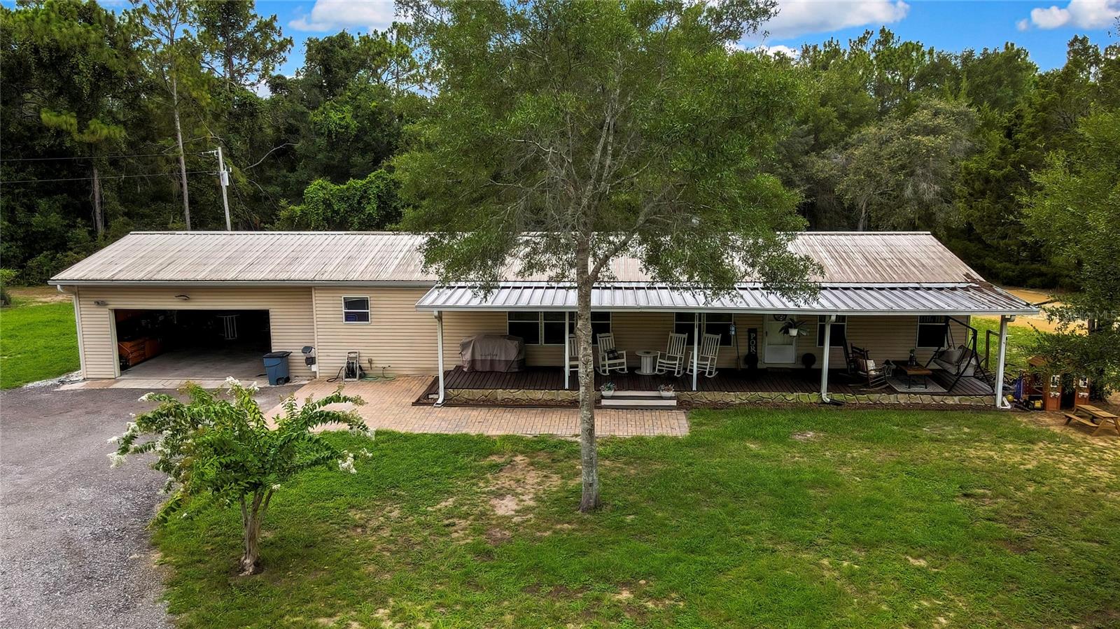 Welcome to your dream country retreat in beautiful Brooksville, Florida. This spacious 3-bedroom, 2-bathroom home sits on a fully fenced 2.5-acre lot, offering the perfect blend of privacy, open space, and modern comfort. With 1,620 square feet of living area, the home features a bright and open layout filled with natural light, ideal for both relaxing and entertaining.
Recent upgrades include a brand-new private well, new stove and dishwasher, serviced AC system, and updated bathrooms with new toilets and sink faucets. The split-bedroom floor plan offers added privacy, with a comfortable primary suite and ample storage throughout.
Outside, the property is packed with features for those seeking a self-sufficient lifestyle or just room to roam. A garden and chicken coop provide a homesteading setup, while a one-acre fenced pasture with a cow stanchion and stall is perfect for livestock or hobby farming. The massive 42x42 detached garage offers endless possibilities for storage, workshop space, or equipment use. Fifteen loads of fresh crushed millings have been added to the long driveway, and a private dirt bike track brings fun and adventure right to your backyard. Wind down in the evenings by the fire pit and enjoy the peace of rural living.
Conveniently located just minutes from Brooksville’s town center, restaurants, and shopping, this property offers the best of both worlds: wide-open space and everyday convenience. Don’t miss your chance to enjoy this one-of-a-kind home—schedule your private showing today.