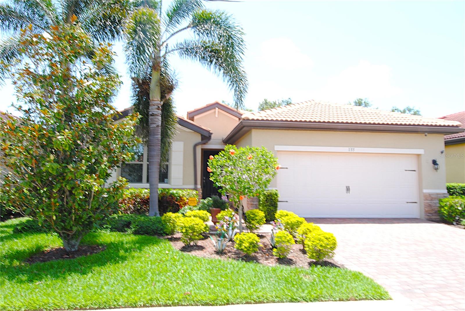 Beautifully maintained 3 bedroom, 2 bath, 2 car garage. The "Avon" features 1641 sqft of open living in the gated community of Toscana Isles. Home is built with a tile roof and features a paver driveway, and 24x10 covered and screened paver lanai. This former model home offers many upgrades including crown moulding, custom tile guest bath shower, partial wood flooring, custom blinds throughout, and epoxied 2 car garage floor. This home offers ample storage including a large walk-in kitchen pantry, 2 linen closets, separate coat closet, and walk-in closets in the master bedroom and guest bedroom. The owners have maintained the home well including new sod and complete cleaning of the roof and exterior.