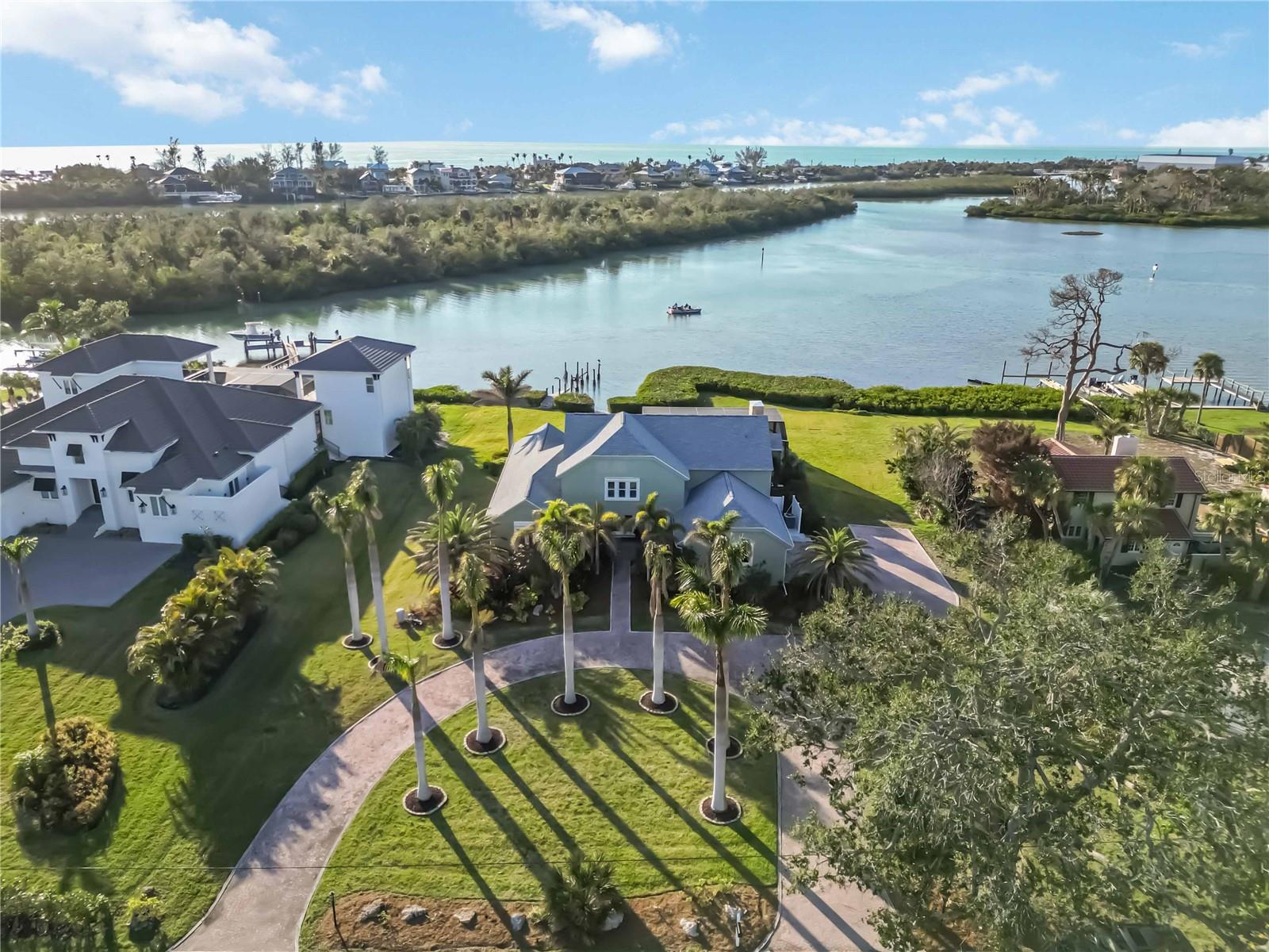 BAYFRONT HOME~DOLPHINS IN YOUR BACKYARD! AMAZING SUNSET VIEWS - PRICE IMPROVEMENT! This stunning 6 bedroom, 4 bath retreat is perfectly situated on almost an acre offering luxury living with 180 degree water and nature views. The home experienced NO FLOODING from the hurricanes and the sellers are offering a $40k credit towards a new dock. Step inside through the double doors to an expansive open-concept floor plan featuring full bay views, abundant natural light and new hardwood floors throughout. The unforgettable kitchen is a true masterpiece, with a 10 ft. island, eat-in dining area, floor to ceiling closet pantry, custom wood cabinetry and many more updates making this the perfect place for entertaining and everyday living. Off the kitchen, is a family room (or captivating formal dining room) with soaring ceilings, a decorative stone fireplace and sliding doors providing access to the expansive lanai and saltwater pool. A guest bedroom is conveniently located from the family room. The luxurious primary suite offers direct views of the bay with an en-suite spa bathroom and oversized walk-in closet. A bedroom is conveniently located close by for a home office/library or nursery. On the second floor ,three additional bedrooms accompany a second family room/media room already plumbed for a wet bar. From there, step outside to your own private sundeck, a screened lanai and open-air living space. A perfect space for morning yoga, JULY FIREWORK displays and serene relaxation as you watch the DOLPHINS, MANATEES and SUNSETS in your hammocks. No detail was missed. The oversized garage includes hookups for RV freshwater and electricity as well as an EV/Tesla charging station. Whether you love water activities or watching nature, the home is perfect for outdoor living offering both seclusion and convenience with easy access to the nearby beach (1.4 mile), shops, restaurants, downtown Venice and top rated schools. Don't miss this must-see dream home, schedule a showing today!