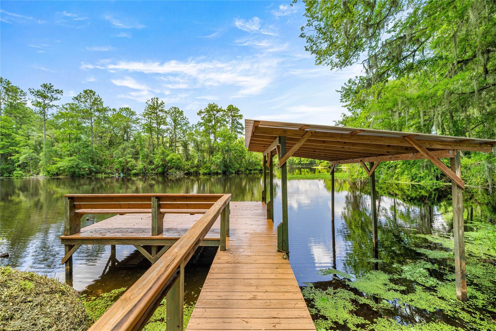 WATERFRONT PARADISE! BOAT DOCK! BOAT HOUSE!
Welcome to your dream riverfront escape in the heart of Dunnellon! This beautifully 3 bedroom, 2-bathroom home with a 2-car garage sits on an impressive 247 feet of pristine waterfront on the Withlacoochee River, just minutes—or a short boat ride—from the crystal-clear Rainbow River. Step inside and be greeted by imported Italian tile floors, a cozy wood-burning fireplace, and panoramic river views through expansive glass windows that span the rear of the home—designed to bring the natural beauty of the outdoors inside.
Enjoy direct access to the San Jose Blvd Trailhead, offering paved walking and biking trails perfect for outdoor enthusiasts not to mention the abundant deer and other wildlife on this protected Greenway. Step out to your newer boat house, dock, and oversized back deck—ideal for relaxing, entertaining, or launching your next river adventure.
The property is a true gardener’s delight, with a beautifully landscaped yard featuring orange, lemon, grapefruit, and avocado trees, along with a cascading grapevine that adds to the lush, tropical ambiance. Freshly painted outside, this home also features a paved driveway and a new storage building conveniently located beside the garage. Enjoy the peaceful, small-town charm Dunnellon is known for, with nearby top-rated schools, charming shops in the Historic District, and the World Equestrian Center just 20 minutes away. Plus, you're just a short drive from the Gulf of Mexico. Homes of this quality, character, and location rarely come along—don’t miss your opportunity to own a piece of Florida’s waterfront paradise! Seller will consider Owner Financing.