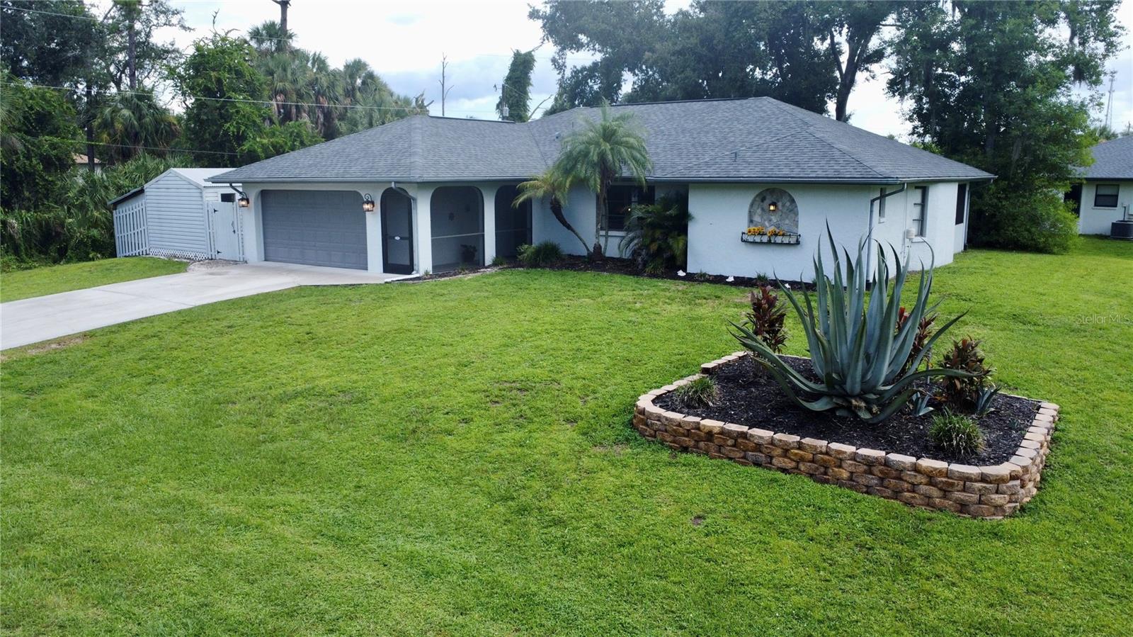BRAND NEW ROOF AUGUST 2025 because they are selling! Spacious 3-Bedroom Home on Oversized Corner Lot with Mature Oaks!
New Roof (8/2025), New high-efficiency AC/heat pump and R-38 attic insulation that cut electric bill in half for Seller (2024), New water heater (2024), Septic pumped and inspected (11/2023), Oversized 20' x 12' shed with double doors, large enough for a riding mower or workshop space with electric and a/c wall unit.
Welcome to your private retreat in a quiet, low-traffic neighborhood where walking & biking are common in this community. Set on an oversized corner lot shaded by majestic oak trees, this 3-bedroom, 2-bath concrete block home offers the perfect blend of comfort, function, and outdoor living. ** NO HOA- NO DEED RESTRICTIONS- X FLOOD ZONE ** A long screened front porch adds charm while adding a perfect spot for package deliveries as you enter the home.
Inside, natural light pours through a large front window and pocket sliding glass doors, brightening the open living and dining areas. The doors open to a 32' covered, screened lanai, ideal for entertaining or simply enjoying peaceful views of your beautifully landscaped backyard. The split floor plan ensures privacy, with a spacious primary suite featuring double walk-in closets, a granite-topped dual vanity, and a walk in shower. Guest bedrooms are generously sized with ceiling fans throughout, while the guest bath includes a tub/shower combo with glass doors.
The kitchen and dinette area have a sliding door to access the large screened lanai, making indoor-outdoor living a breeze. Amazing eat at breakfast bar for those watching the chef create their meals.
Great for full time, seasonal or rental living and you’re just a couple miles from shopping, dining, entertainment, public boat launches, less than 17 miles to Gulf beaches and multiple golf courses and I-75 about 6 miles.