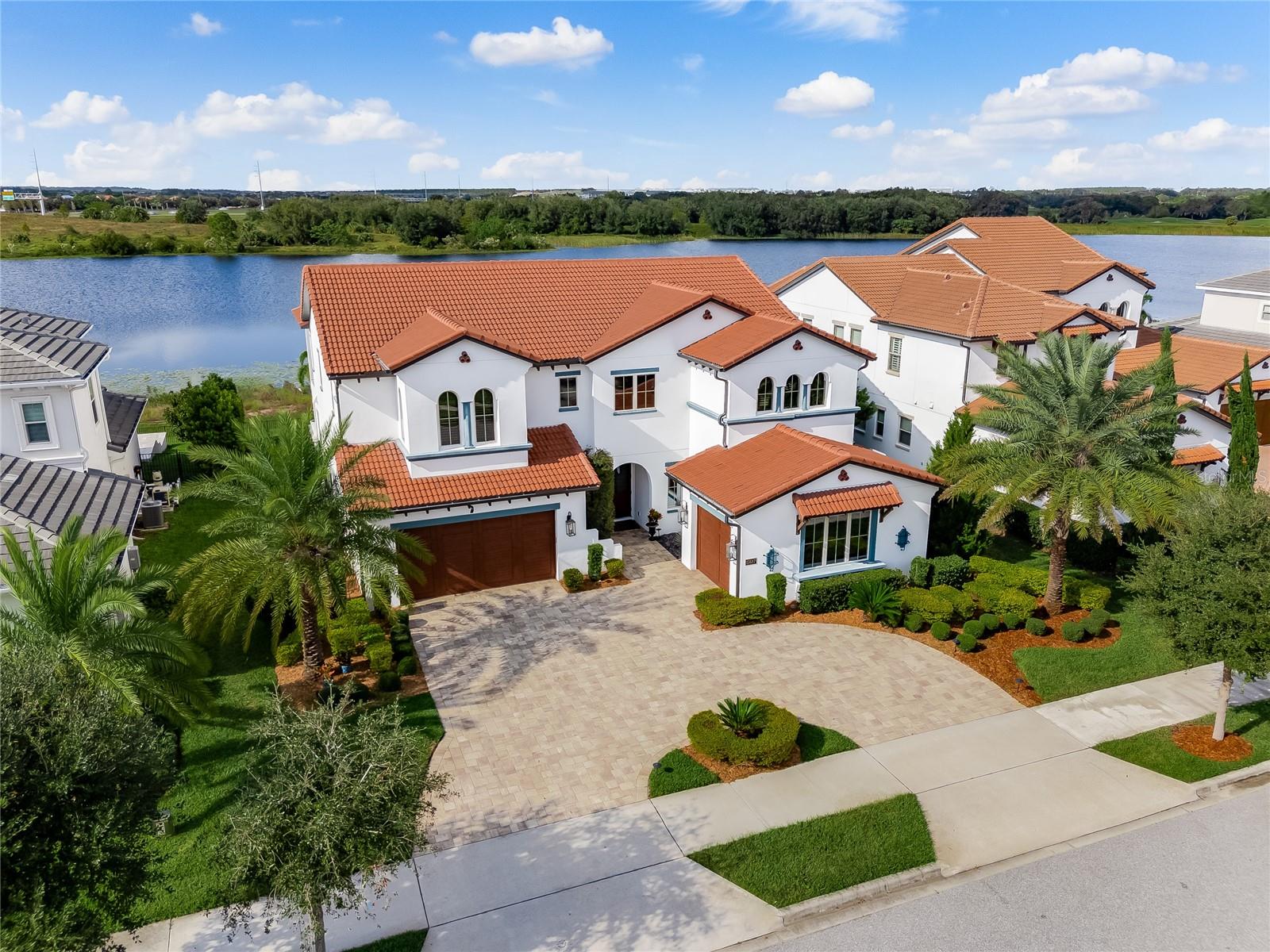 Welcome to your new Lifestyle at 15687 Panther Lake Dr, Winter Garden, FL 34787! Presenting the Bramante Spanish Colonial Estate, a masterpiece by the award-winning builder Toll Brothers, setting the standard for luxury and sophistication in the highly sought-after Horizon West corridor of Winter Garden and nestled on the shores of Panther Lake. This exceptional 4,267-square-foot home offers a level of elegance and refinement that is unmatched and sunset views that are Instagram worthy! This sophisticated residence features 4 bedrooms, 4.5 bathrooms, open loft/bonus room and a split 3-car garage. Upscale touches such as a gas fireplace, coffered ceilings, maple flooring and custom landscaping. The heart of the home is the gourmet kitchen, equipped with top-of-the-line Wolf appliances and a Sub-Zero 84” stainless steel refrigerator with a wine storage area. The kitchen island overlooks the elegant dining and family room, offering panoramic views of the luxurious saltwater infinity pool and spa. Did I mention the incredible sunsets?? If you love to host, this layout is a delight for flow and with the outdoor entertaining area, it's just seamless! On the main floor you do have a guest room with full en-suite! As you approach upstairs, a spacious loft and additional bedrooms await, while the luxurious primary suite offers a private sanctuary with its own balcony overlooking the lake. The suite’s spa-inspired en-suite bathroom features a freestanding tub, a frameless rain shower, dual vanities, a private water closet, and two walk-in closets, all finished with stunning attention to detail. Secondary rooms are generous in size for family and guest. Relax on your private lanai and enjoy your saltwater pool for dips in the pool while over looking Panther Lake.This home is the Epitome of Luxury and has been so well cared for. Your HOA INCLUDES LAWN CARE, INTERNET AND CABLE. Lakeshore residents enjoy unparalleled amenities, including the chance to watch Disney’s Magic Kingdom fireworks over Panther Lake. The community offers a 4,132-square-foot clubhouse, resort-style pool, state-of-the-art fitness center, yoga room, beach volleyball courts, fire pit, kayak launch, and more. Conveniently located near the 429, Windermere, the Florida Turnpike and Disney's Theme Parks! Highly rated schools and new minutes to downtown Winter Garden. Please take a moment to watch the incredible video of this home and call for your private showing.