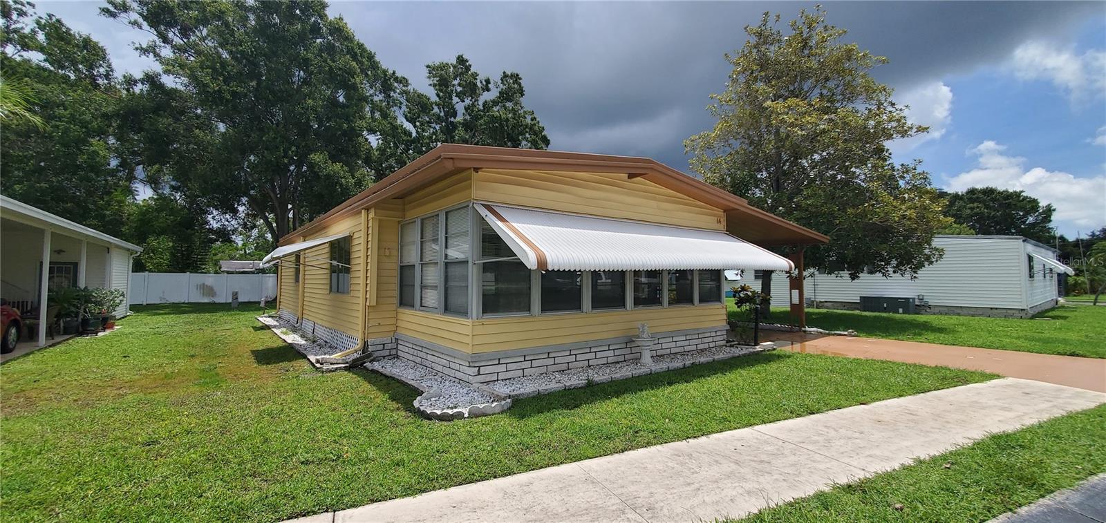 Welcome to Greenbrier. A 55 and older mobile home community. Centrally located in Pinellas County, you will find that EVERYTHING you could imagine is within 30minutes of home. From world renowned beaches to record holding professional sport teams, even luxury shopping and dinning! Lot #14 features a large two bedroom, two full bath home with detached workshop and covered parking. Whether you're looking for a permanent residence or a vacation home, this one has it all. From the covered parking, to BRAND NEW HVAC, #14 has been gone through from top to bottom with love and care. Schedule your private showing today! Resident owned community, minimum share value (contact for value) included in purchase price.