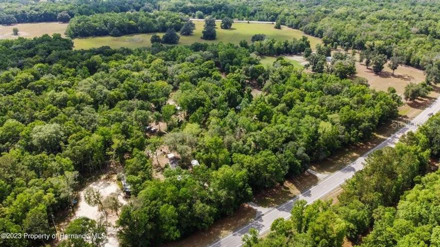Tucked behind a gated entrance, this RARE appealing 5.1 acres is a rare Brooksville find with electric, septic, brand new water softenerwell, 6 nice quality storage buildings, a natural creek across the property, 2/3 of the property has been cleared, and a newly renovated dog kennel with a nursey bulding perfect for the new born puppies. Give your furry companions a secure place to rest with a newly renovated dog kennel. The great outdoors can be exciting for your pets, but when you're not there to supervise, it's nice to know your dogs are safe inside a quality dog kennel or dog run with plenty of room to stretch out. The 5.1 acres provide plenty of room for recreation—multiple places for power sources around the perimeter. You are located in a quiet area of residential development on agricultural parcels. Just a short drive to parks and open spaces (freshwater rivers and springs, state forests and preserves, and Gulf waters offer opportunities for many land and water adventures for residents and tourists.). You'll enjoy amazing privacy. The mobile on the Property is 3 bedrooms 2 baths, and 1,200 sq. ft. The owner never lived in the home; it is being used as storage.