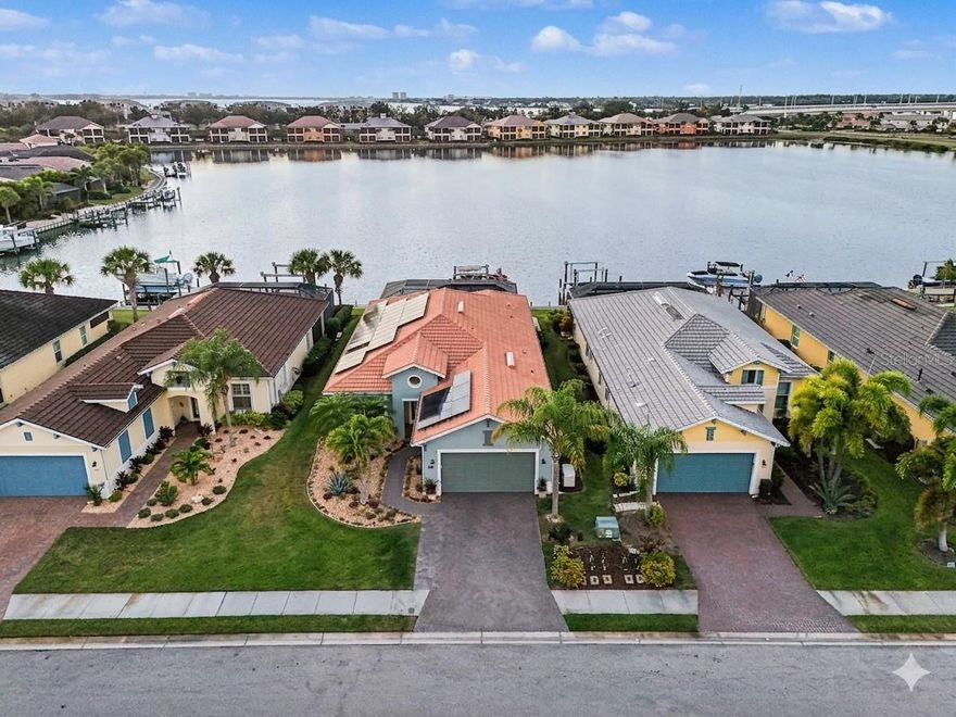 Why settle for a canal when you can have a lake (WITH access to the Gulf)?  Wake up to soft water views, warm morning light, and the kind of peace that makes home feel like an escape. From the moment you arrive through the gated entry and pull onto the sweeping paver driveway with professional lighting, everything about this property feels designed to slow life down in the best possible way.

Open the wall of sliding glass doors and let the coastal breeze move through the living spaces. Spend quiet mornings with coffee overlooking the water, easy afternoons on the lanai, and evenings beside the saltwater pool as the waterfall spills into the background. And when you are ready to get out on the water, you do not have to wait for some future plan to make it happen. This home includes the boat, along with a private dock and 12,000 lb boat lift, so your waterfront lifestyle starts the moment you move in.

Inside, the home blends warmth and function with thoughtful design throughout. Exposed wood ceiling beams bring character to the main living area, creating a space that feels both elevated and inviting. The kitchen has been beautifully refreshed with granite countertops, a gas range, neutral tile backsplash, and reverse osmosis water system. A dedicated office with French doors gives you privacy when needed, while the split layout offers a comfortable guest wing with two bedrooms connected by an updated Jack and Jill bath.

The primary suite feels like its own retreat, highlighted by shiplap tray ceilings and a spa inspired bath with custom framed mirrors, a soaking tub, and a glass enclosed shower. Every space has been carefully considered to make daily living feel easy, comfortable, and refined.

Beyond the home itself, Tidewater Preserve adds another layer to the lifestyle with gated entry and a resort style setting along the Manatee River. Residents enjoy access to resort style amenities that make it easy to stay active, social, and connected to the waterfront setting.

Just as appealing is how connected it feels when you leave the gates. The location offers convenient access to I 75, UTC shopping and dining, downtown Bradenton’s waterfront, the airport, and the area’s well known beaches, so it is easy to enjoy both a tucked away waterfront setting and the everyday convenience of being close to the places people actually want to go.

Outside, the lanai is enhanced with Clearview screening for panoramic water views and motorized screens for added comfort. The finished garage features epoxy flooring and built in storage, while practical upgrades like a whole home water softener, laundry room utility sink, and generator hookup add convenience behind the scenes. Leased solar panels are also in place and can be assumed by the buyer or removed depending on preference.

This is the kind of home that makes it easy to picture a different pace of life. More time outside. More time on the water. More mornings that start slower and evenings that last longer.