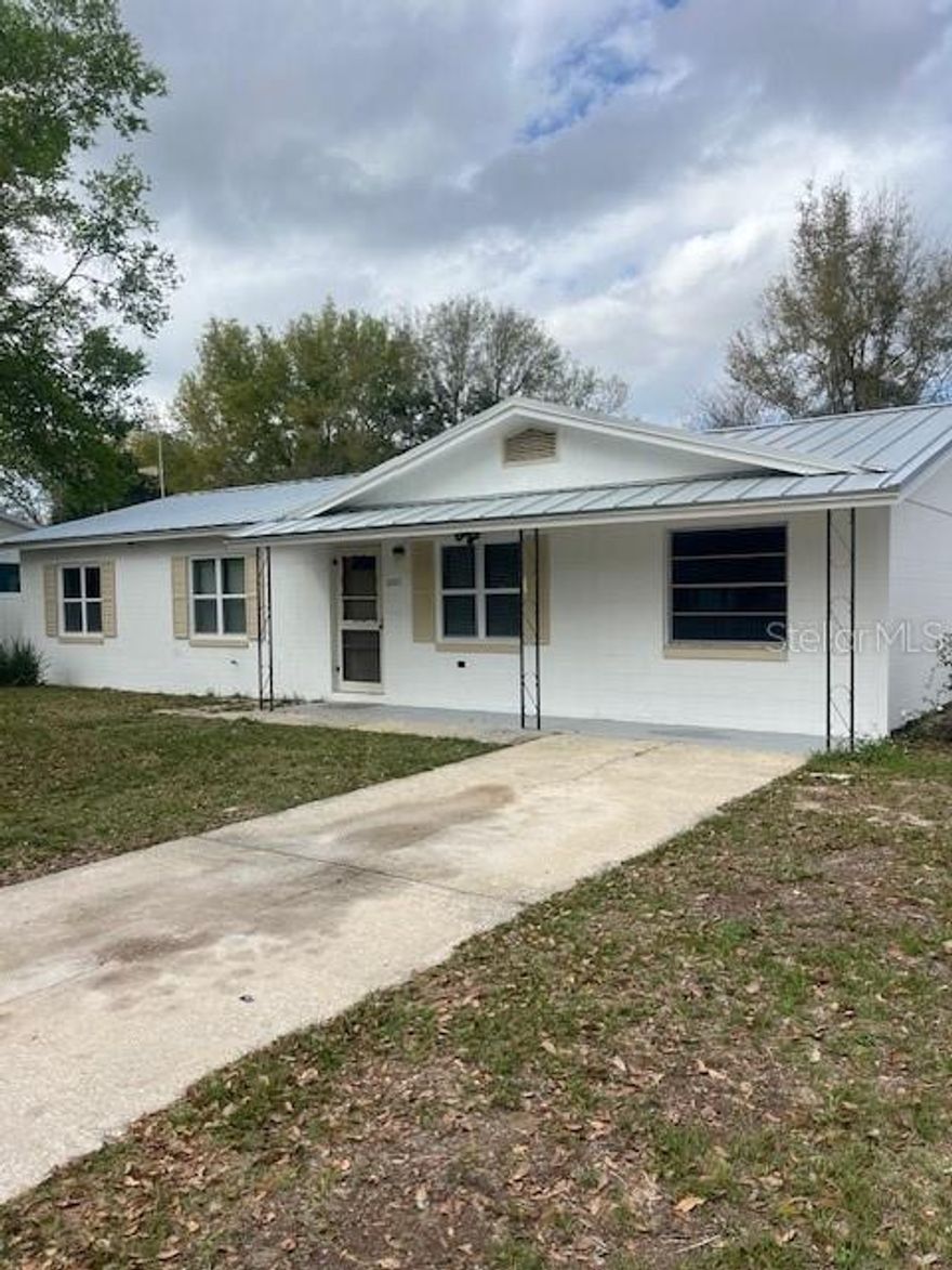 This block home is located in the heart of Mt Dora and features an all metal roof, lots of yard space and of course the all important picket fence! Inside you will find a unique layout with some opportunities for your own improvements. The garage has been converted to a bedroom with a large closet which gives you 3 bedrooms plus an office and the large family room has lots room to entertain and relax. Out back is a covered patio with views of the back yard. There is also a large shed for storage. Close to shopping and dining and all the fun activities of Mt Dora. Call today to set up a viewing!