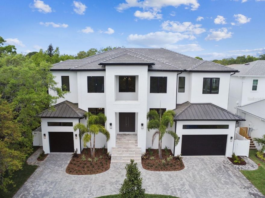 -NOW COMPLETE- Livistona Homes Luxury New Construction - 6 bedrooms, 6.5 baths, 3 car garage, elevator, pool, spa, waterfall, and more! This stunning home impresses you from the moment you step into the grand entry with w/soaring 24' ceilings, oversized PGT vinyl windows & elegant wood staircase opening to the 2nd floor. The spacious floor plan includes an office (w/french doors), separate formal dining space, butler's pantry w/arched walk-through to kitchen & wine fridge and eat-in breakfast space. Overlooking the backyard is the great room, w/gas fireplace, coffered ceiling, custom wood shelving, and sliding impact glass doors to incredible outdoor lanai space. The exquisitely designed kitchen features floor-to-ceiling European-style maple cabinetry, Calacatta quartz counters, pot filler, a 72" Subzero fridge, and Wolfe and Miele Appliances. The backyard boasts a large travertine lanai & pool deck, outdoor kitchen w/ gas grill, saltwater pool, heated spa, waterfall feature, and outdoor fireplace. French doors lead from the lanai to the main floor guest bedroom or bonus space w/ensuite. 5 bedrooms on the 2nd floor and a separate bonus room with a wet bar. Private & large master wing features tray ceiling, walkout to balcony, large bathroom w/ double sinks, soaking tub & oversized walkthrough shower. Completing the elegance of the master is an over 250 sq ft walk-in closet w/ custom shelving & island. This home spares no expense w/finishes - hardwood throughout, two-story block construction, 9 ¼” baseboards, 7 ¼” crown moulding, smooth finish drywall, closet systems in all closets, 8’ solid core doors, elevator, two laundry rooms (one on the main floor) hurricane impact windows & doors, tile/aluminum roof, & wiring for surround sound & security. Mabry/Coleman/Plant school district.