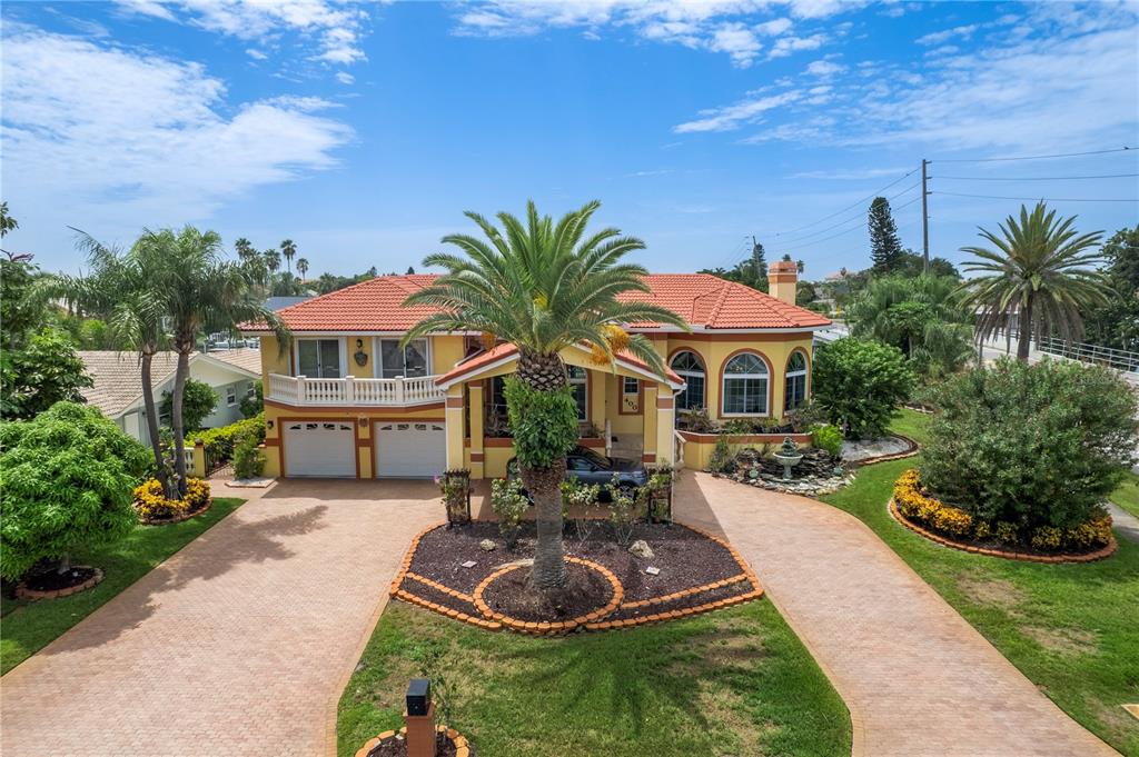 Welcome to Tierra Verde and to this beautiful and spacious corner Waterfront Property. Enter your home after pulling into your circular drive with portico to enter one of two garages or enter through the leaded glass etched front door. The lobby features marble flooring leading to the living area with oak wood flooring throughout the home. This home has 3 to 4 bedrooms, 4 baths, a 2-car oversized garage, pool, spa, dock with lift and greenhouse. The bonus room, behind the garage, has 4th bedroom/office, full bath and French doors that lead to the pool and dock/waterfront. There is a wood burning fireplace in living room and 2 sets of French doors off the kitchen and Living room. The large laundry room has washer/dryer/storage space and a door that leads to the side of the house. The covered patio has a screened outdoor cooking area with propane grills with 2 tanks, sink and an island to enjoy your favorite foods and beverage. The pool has a spa with nonskid stairs. There is a 98 ft seawall with boat dock and lift that is currently having the motor replaced. The home boasts of Brazilian Mahogany cabinets and Oak wood floors. Ceiling are 13 to 15 feet high on the main level with appox 8 ft ceilings in bedrooms upstairs. Each upstairs bedroom has a Juliet balcony, the Master bedroom has a large balcony overlooking the water. The garage door and windows are hi impact hurricane rated. The French doors are hi impact rated with accordion shutters. There are 4 exterior security cameras mounted in front and back of home and additional ones inside. The home is prewired for speakers. There are 2 A/C units, one installed in 2012 and other in 2021. The hot water tank was installed in 2020. The front of home has a Cascading water fountain and Sprinkler system. Home also has a water softener. The kitchen has Brazilian Mohagany cabinets, stainless steel appliances, stove, double oven, microwave, coffee station, tiled flooring, granite countertops, Sun-Tek fixed impact skylight and reverse osmosis water filtration under sink. The master bath has Brazilian Mahogany cabinets, Granite counter tops, a large walk-in shower, large jacuzzi tub and a separate powder room with bidet, toilet and sink. The Master bedroom has a large screened in balcony overlooking the waterfront, with accordion shutters. There is a sunken living room with French doors leading to patio, sitting areas off of kitchen, a full bath on the main level with another possible office or 5th bedroom if you return the doors and closet doors. It is currently being used as a dining room. This house offers space for hosting family and friends, get togethers, both indoor and outdoor, swimming or boating. Tierra Verde is just minutes from St Pete Beach, Fort Desoto state park and the top-ranked beaches of St. Petersburg. Fort Desoto offers something for everyone, from beaches to bike paths. Come by boat or car after scheduling your showing today! Enjoy Resort-style living in this beautiful Tierra Verde home.