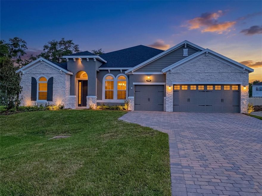 One or more photo(s) has been virtually staged. Welcome to 132 Lake Drive in sought-after Oviedo, where stylish new construction, thoughtful upgrades, and everyday comfort come together in one impressive single-story home. Built by M/I Homes, this 4-bedroom, 3.5-bath residence also features a flexible fifth room ideal for a den, office, or bonus space, offering 3,035 square feet of beautifully designed living space on an oversized homesite with a 3-car garage.

Step inside to a bright, open layout with a seamless flow that is perfect for both daily living and entertaining. The spacious main living areas connect effortlessly to a chef-inspired kitchen featuring modern appliances, a striking vent hood over the cooktop, and abundant storage in crisp white shaker cabinetry. Top-end Sunburst Shutters have been installed throughout the entire home, adding timeless style, privacy, and quality craftsmanship. Remote-control ceiling fans throughout the home further enhance comfort and convenience.

The owner’s suite is a true retreat, complete with a tray ceiling, two oversized closets, and direct access to the lanai. The spa-like bath is designed to impress with marble-look tile, separate vanities, a freestanding vessel tub, and a beautifully finished walk-in shower. The additional bedrooms are generously sized, offering comfort and privacy for family members or guests, while the well-appointed full baths and convenient powder room feature contemporary finishes throughout.

Outdoor living is just as inviting, with a large 16'7" x 20'7" covered lanai that creates the perfect space for morning coffee, evening relaxation, or weekend gatherings. The oversized lot provides a broader streetscape presence and a sizable backyard with plenty of room to enjoy the Florida sunshine.

The garage has also been upgraded with a premium three-layer floor coating system featuring a polyurea base and polyaspartic topcoat, designed to resist chipping, scratching, and scuffing. This finish is four times more durable than epoxy and built for long-lasting performance.

Ideally located near top-rated schools, parks, shopping, dining, and major roadways, this home offers the best of Oviedo living in a vibrant and convenient setting. This is your opportunity to own a beautifully upgraded new home with space, style, and exceptional features throughout.