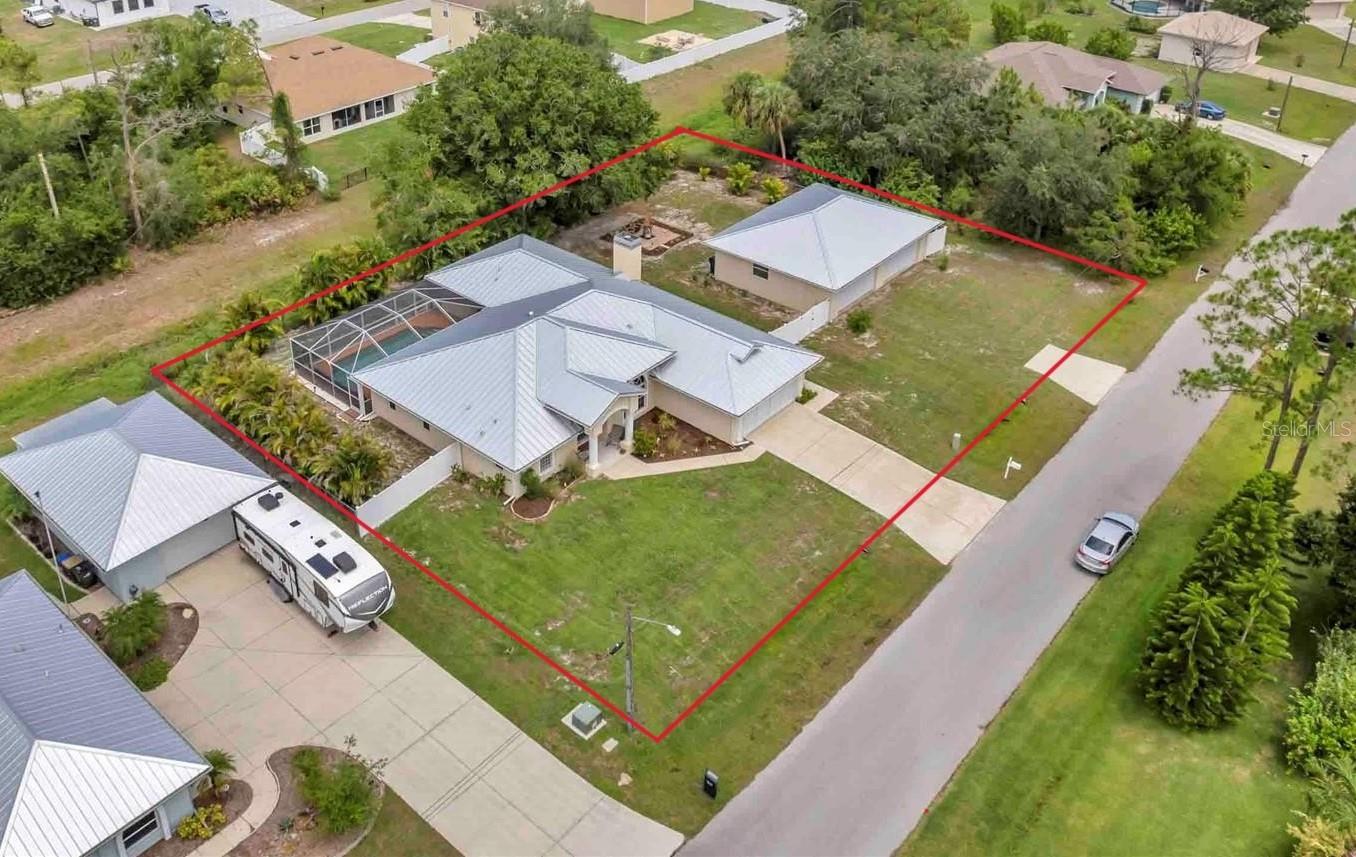 Welcome to your Florida retreat! Tucked away on an oversized lot with mature tropical landscaping in sunny North Port, this spacious 4 bedroom, 2 bathroom pool home offers that relaxed, coastal lifestyle you’ve been dreaming of.
From the moment you open the door, you’re welcomed by tall ceilings, tons of natural light, and an immediate view of the heated pool — the kind of first impression that makes every day feel like a getaway. With over 2,300 square feet of clean-kept living space, this home was designed for comfort, functionality, and good vibes.
The kitchen has been fully remodeled and shines with upgraded granite countertops & stainless steel appliances,— perfect for everything from quick breakfasts to weekend hosting. Ceramic tile flows throughout the home, keeping things cool, low-maintenance, and cohesive.
The primary suite is a total retreat, complete with custom walk-in closets and a recently remodeled walk-in shower that gives off spa energy. Two additional bedrooms provide space for guests or family, while the dedicated office offers a quiet, tucked-away spot for working from home, creative projects, or just closing the door and having some “you time.”
Step out back, and your Florida lifestyle kicks into full gear — the heated pool is the centerpiece of a backyard built for both relaxing and entertaining. Surrounded by lush, mature landscaping, a paver deck fire pit area, and a fully fenced yard, there’s room for the whole family, pets, hammocks, and good times under the stars.
Saving the best for last - for those who need space to tinker, create, or store all the toys — the detached, air-conditioned 4-car garage with impact-resistant doors checks all the boxes. Whether it’s your workshop, gym, or weekend escape space, it’s ready to go.
And yes — it gets even better:
This home is not in a flood zone — so no flood insurance required
There’s no HOA and no CDD — enjoy your space and your freedom
The split floor plan offers privacy and flow
The home has been meticulously maintained, and you can feel the pride of ownership in every detail
Just a short drive to shopping, dining, nature trails, golf, and the Gulf Coast’s best beaches
Whether you're lounging by the pool, working in your home office, or relaxing around the fire pit at sunset, this home offers the perfect blend of chill, charm, and space to truly live. Come experience what easy Florida living really feels like.