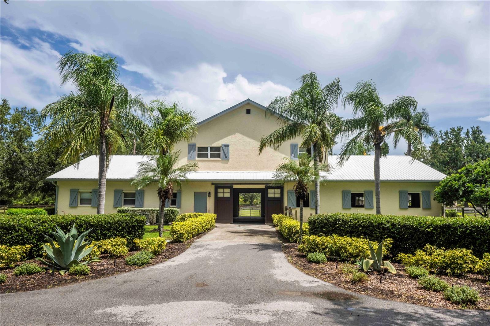 Welcome to a truly unique opportunity in the heart of Lakewood Ranch! This rarely available 9.7-acre property is nestled within the exclusive Sarasota Polo Club, offering a premier equestrian lifestyle just minutes from all the conveniences of town.
As you enter through the gates, you’re greeted by a stately oak-lined driveway that sets the tone for this remarkable estate. The property features a gorgeous 8-stall center-aisle barn with a spacious office, tack room, and a beautiful 2-bedroom, 2-bathroom apartment upstairs — perfect for owners, guests, or staff.
In addition, there’s a 16-stall barn complete with a 1-bedroom apartment, providing ample accommodations for horses, grooms, and trainers. Both barns are thoughtfully designed for functionality, comfort, and the highest standards of equine care.
Located within minutes of the acclaimed Out-of-Door Academy, this property is also a quick golf cart ride to Waterside, Lakewood Ranch where you can enjoy boutique shopping, lakeside dining, weekly events, and so much more. With ample space to build your dream home, this estate offers endless possibilities for creating your perfect equestrian retreat.
Whether you’re a polo player, competitive rider, or simply a horse enthusiast, this property offers an unmatched combination of location, facilities, and charm. Enjoy the prestige of the Sarasota Polo Club community while being just moments from shopping, dining, schools, and Lakewood Ranch’s vibrant amenities.
Don’t miss this chance to own one of the area’s most coveted equestrian properties!