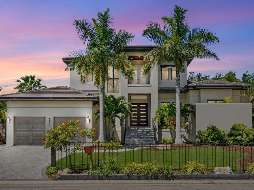 New price! Experience the epitome of Siesta Key living in this exquisitely crafted residence near Siesta Village and renowned pristine beaches, with every conceivable amenity nearby. On a generous one-third-acre lot, this 2019 custom masterpiece by award-winning John Cannon Homes epitomizes luxury and sophistication. Boasting four spacious bedrooms, an office, and five baths, this home is an entertainer's dream, designed to host large gatherings with ease and elegance. Built with an unwavering commitment to quality and luxury, every detail has been thoughtfully considered to offer unparalleled comfort and convenience. Innovative technology is seamlessly integrated throughout the home, allowing for remote control from your smartphone, a cutting-edge media system for immersive sound and visual experiences, a Lutron lighting and blind system, and a reliable backup generator, ensuring uninterrupted enjoyment. The open-concept floor plan offers soaring ceilings illuminated by natural light. The great room flows seamlessly to the dining area and the fabulous chef’s kitchen, which features sleek custom cabinetry, an expansive island with seating, and quartz counters. Top-of-the-line Thermador appliances include a six-burner natural gas range and a built-in Miele coffee system, ensuring culinary excellence. The primary suite is a sanctuary of relaxation, welcoming its occupants after a day filled with sun and fun. Guests are pampered with their own en-suite baths and access to bespoke entertainment options, ensuring privacy and luxury for everyone. The heart of this magnificent property is the expansive outdoor lanai, featuring a stunning pool set against the backdrop of silver travertine tile, a rejuvenating spa, and a fully equipped kitchen and bar area, living room and fireplace, promising unforgettable moments under the sun or stars. As the sun sets, the outdoor living space becomes a central gathering spot, where music, laughter, and culinary delights blend to create the perfect evening. An automated irrigation system maintains lush greenery. A high-ceiling garage with a two-car lift provides ample space for your luxury vehicles, while a comprehensive camera system, impact doors, windows, and garage door, and a natural gas-powered generator ensure security and peace of mind. The high-quality construction offers an added benefit with reasonable insurance rates. This home promises a life of exquisite luxury and unmatched convenience, where the car keys are forgotten. Enjoy the convenience of being near the vibrant Village, as well as the white quartz sands and azure waters of Siesta Beach. Welcome to your paradise on Siesta Key, where every day there is a testament to the beauty of island living.