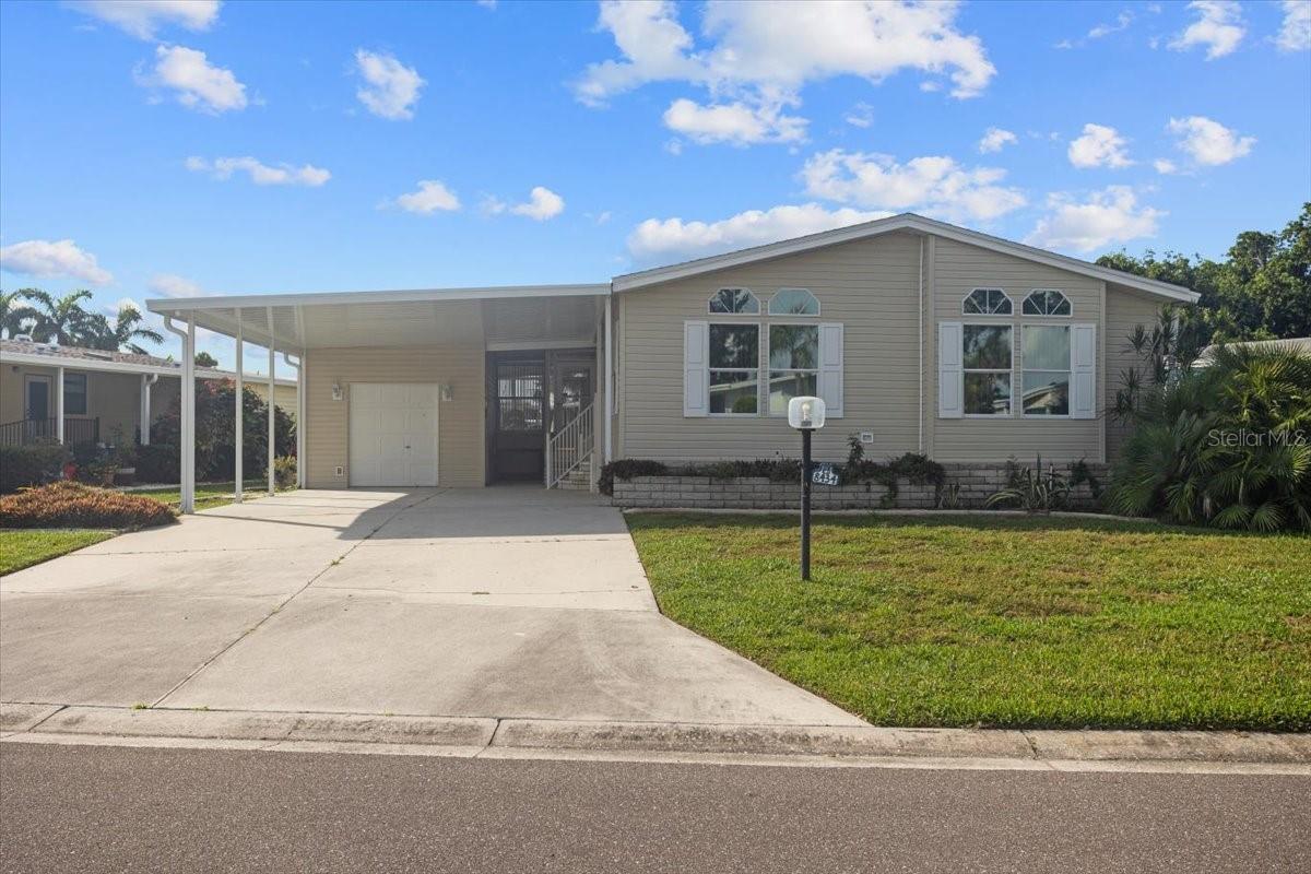 Are you ready to sign on the dotted line for your forever Florida home? The time is here! This beautiful 2 bedroom 2 bath home has an open floor plan, a bonus room, a mud room and a completely enclosed Florida room to take in the beautifully landscaped backyard at sunrise. The mud room can easily be converted back into the inside laundry room if that is your desire! The kitchen boasts a built in desk as well as a dinette. This home comes with all the furnishings seen in the photos. The roof was replaced in 2025 along with the carport roof and all new vinyl siding and a new A/C system was installed in July of 2021. Imperial Lakes Estates is a 55+ Active Community, Offering Pickleball, Tennis, Water Aerobics, Group Outings, and so much more!