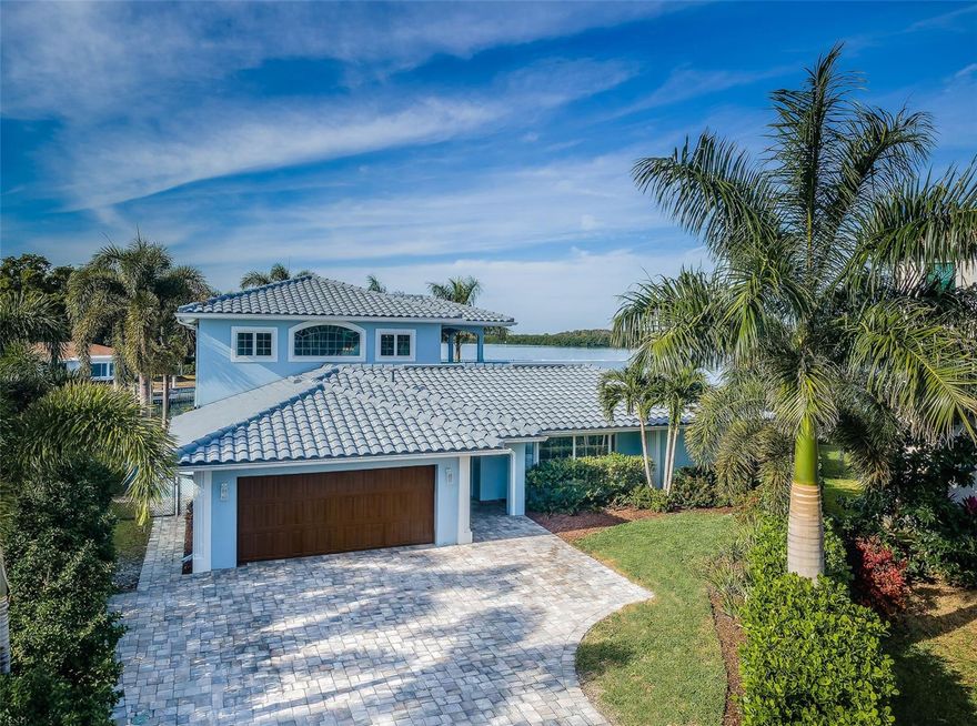 LOCATED AT THE END OF A FINE CUL DE SAC IN A WONDERFUL WATERFRONT BOATING COMMUNITY, THIS TERRIFIC RESIDENCE DELIVERS SPECTACULAR OPEN WATER VIEWS OF TAMPA BAY, WITH VISTAS OF DOWNTOWN TAMPA IN THE DISTANCE!  With 137 feet of sweeping waterfrontage, this exciting 5 bedroom, 4 bath home offers a spacious 4600sqft under roof.  An inviting covered entry opens to a lovely foyer and expansive living room area.  Step through to the dazzling chef’s kitchen and taking in gorgeous views of the pool deck and waterfront.  Kitchen enjoys elegant quartz surfaces, herringbone-pattern tile backsplash, coastal-white shaker-style solid wood cabinetry, high-quality bespoke appliances, gas cooking and a wide breakfast bar that seats 4.  The huge family room with built-in credenza/media center transitions to a 290sqft covered pool deck with gorgeous views of the waterway.  First living level boasts a private waterfront guest suite with a richly-finished full bath, sizable walk-in closet and dedicated access to the covered pool deck.  2nd first level bedroom suite is equally well-appointed with a beautiful full private bath.  4th bedroom makes for an ideal office/den with amazing views of the water.  The 3rd guest bath functions as the pool bath and includes stunning dual vanities and splendidly-finished shower/tub combo.  First level bathroom vanities were built by the renowned James Martin.  Step up to the incredibly owner’s suite and savor its remarkable panoramic seascapes!  Bedroom opens to an impressive 500sqft partially-covered deck with miles of dramatic open water views.  Suite features a large, built-in multi-purpose entertainment center, a separate sitting room (office) with built-ins, oversized walk-in shower with dual shower heads, towel warmer, dual quartz vanities and two sizable walk-in closets.  Out back, a substantial paver deck surrounds the superb Pebbletec pool – with big, brilliant, open views of the waterfront.  Your new seawall supports a generous composite dock with step down for kayak/paddleboard launch and two boat lifts (13K lb and 10K lb), for maximum flexibility and rapid access to the open water and downtown St. Petersburg.  Home features a luxury indoor laundry, salt water pool system, high-quality fans, beautiful flooring, an oversized garage and much, much more.  An outstanding value in a great waterfront location near downtown St. Petersburg and well-regarded Pre-K – 12 schools!  Measurements/dimensions are estimates, buyer to verify.