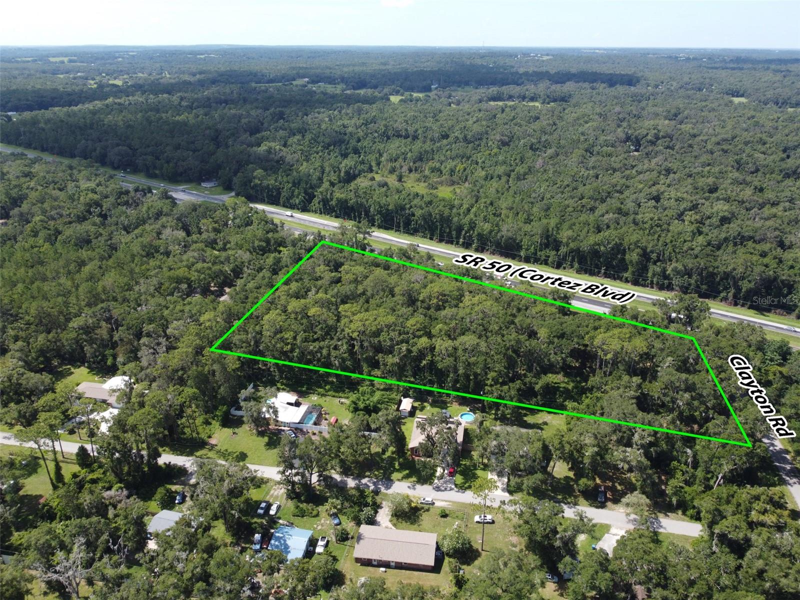 Outstanding commercial development opportunity along one of Hernando County’s most traveled corridors. This 5.50-acre parcel features approximately 710 feet of frontage on Cortez Boulevard (State Road 50), with an Average Annual Daily Traffic (AADT) count of 29,500 vehicles per day. Zoned C2, the property is ideally suited for a wide range of commercial applications—retail, fast-casual or quick-service dining, medical, office, or mixed-use development—subject to county approval. Its prime corner location enhances visibility and accessibility, offering multiple points of ingress and egress—an important advantage for most commercial uses. Water service is conveniently available from Clayton Road. As is typical for this market, municipal sewer service is not available; however, septic systems are widely accepted and utilized throughout the area, making this a practical and feasible option for new development. Located just minutes from the Historic City of Brooksville, this site combines modern development potential with small-town charm. Brooksville is known for its tree-lined streets, preserved architecture, and vibrant downtown—hosting seasonal festivals, farmers markets, and a growing local business scene. This blend of historic character and forward-looking growth has made the area increasingly attractive to both residents and commercial developers. The property is strategically positioned between two major transportation arteries—just 9 miles from Interstate 75 and 10 miles from the Suncoast Parkway—offering exceptional regional connectivity. It is also 12 miles from the Brooksville–Tampa Bay Regional Airport and 52 miles from Tampa International Airport. Downtown Tampa is 47 miles away, while Clearwater Beach, St. Petersburg, and Orlando are all within 65 to 70 miles—placing the site within reach of four major metropolitan areas. For national retailers, commercial builders, and investors seeking visibility, flexibility, and long-term upside in a high-growth corridor, this is a rare and compelling opportunity.
