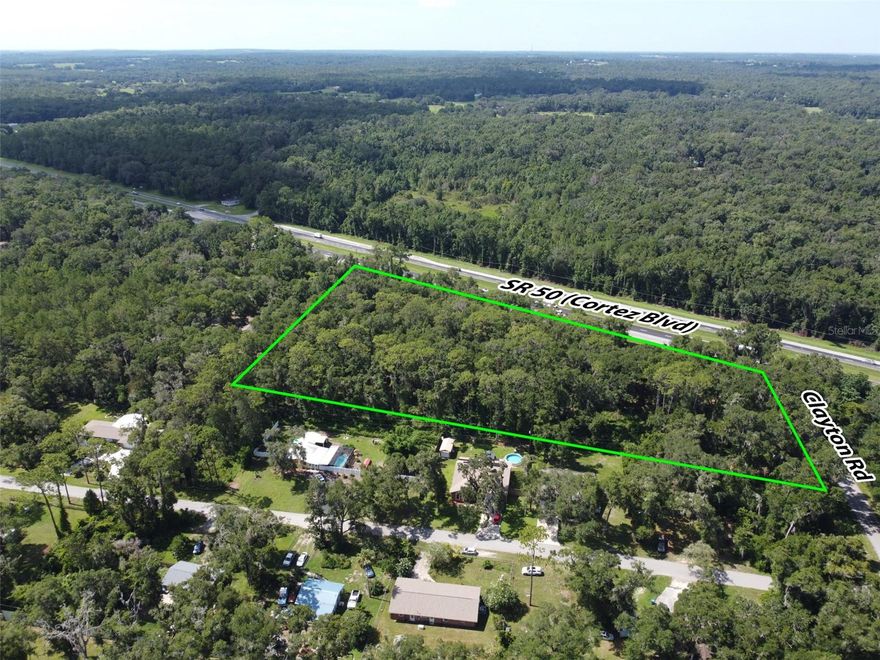 Outstanding commercial development opportunity along one of Hernando County’s most traveled corridors. This 5.50-acre parcel features approximately 710 feet of frontage on Cortez Boulevard (State Road 50), with an Average Annual Daily Traffic (AADT) count of 29,500 vehicles per day. Zoned C2, the property is ideally suited for a wide range of commercial applications—retail, fast-casual or quick-service dining, medical, office, or mixed-use development—subject to county approval. Its prime corner location enhances visibility and accessibility, offering multiple points of ingress and egress—an important advantage for most commercial uses. Water service is conveniently available from Clayton Road. As is typical for this market, municipal sewer service is not available; however, septic systems are widely accepted and utilized throughout the area, making this a practical and feasible option for new development. Located just minutes from the Historic City of Brooksville, this site combines modern development potential with small-town charm. Brooksville is known for its tree-lined streets, preserved architecture, and vibrant downtown—hosting seasonal festivals, farmers markets, and a growing local business scene. This blend of historic character and forward-looking growth has made the area increasingly attractive to both residents and commercial developers. The property is strategically positioned between two major transportation arteries—just 9 miles from Interstate 75 and 10 miles from the Suncoast Parkway—offering exceptional regional connectivity. It is also 12 miles from the Brooksville–Tampa Bay Regional Airport and 52 miles from Tampa International Airport. Downtown Tampa is 47 miles away, while Clearwater Beach, St. Petersburg, and Orlando are all within 65 to 70 miles—placing the site within reach of four major metropolitan areas. For national retailers, commercial builders, and investors seeking visibility, flexibility, and long-term upside in a high-growth corridor, this is a rare and compelling opportunity.