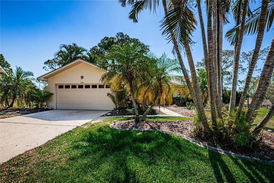 WOW!  Best Golf Course location in Highland Lakes right on the tee-Blue 2 with no worry of golf balls hitting your windows, along with an amazing view, plus no big Oak trees to clean up after and large patio to relax and enjoy the view. As you step inside, you’ll notice the light and bright, open Split floor plan with vaulted ceilings, fans, skylights and recessed lighting & track lighting in many areas. There is a living room/dining room and Great room off the Kitchen. Perfect for family and friend gatherings.  The Kitchen has a large Breakfast bar & huge pantry with lots of cabinets and newer Stainless Steel appliances. The cheerful Master Bedroom has a separate office/den area with 2 closets wall closets and 1 Walk-in Closet. Newer ceramic tile and Laminate floors in Bedrooms. Textured ceilings, Plant Shelves & Plantation Shutters throughout. Relax with your morning coffee all year on the screened lanai. Newer windows, doors, Electrical, Roof 2023, Lanai Roof 2024, A/C 2025, newer washer & newer extra stainless steel refrigerator in garage.  Just 4 houses to the Clubhouse, Community Pool, Hot Tub and Activities such as bingo, cornhole, concerts, dances breakfast events & over 40 activities! Walk, bike or drive to the lodge on Lake Tarpon where they have a Clubhouse, Pontoon boats, boat & RV storage, dock, grills & more!   The $164 HOA includes all this plus three 9 hold Executive Golf Courses with unlimited golf. High & dry (no flood). Close to all your conveniences, restaurants, shopping and just 10 minutes to gulf beaches. COME SEE TODAY!