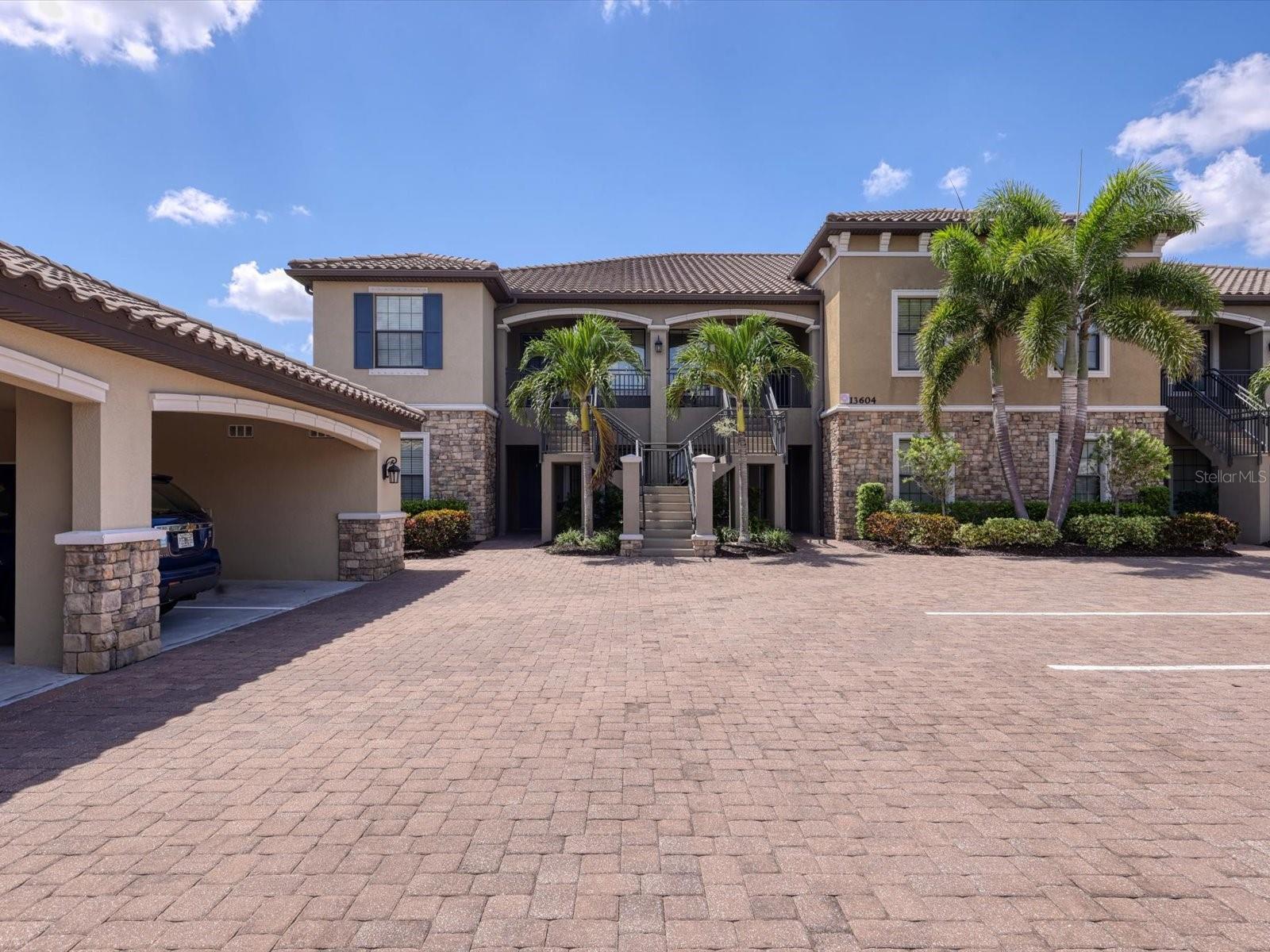 Unfurnished Annual Rental Available Now. This beautiful first 2/2 plus den end unit is flooded with natural light. This unit features an tropical view. Spacious kitchen with white cabinetry, granite, and stainless-steel appliances. There is an eating space in the kitchen, breakfast bar, and pantry. The kitchen is open to the dining room and living room. There is also a den for extra space. The master suite has two walk-in closets, and double sinks, and stand-up shower. There is a covered parking space as well as guest parking. Esplanade Golf and Country Club is known for its resort lifestyle in the heart of Lakewood Ranch. This gated enclave is spread out over 600 acres. You will find a new club house with huge resort style heated lagoon pool and spa, with private cabanas, a 16,000 foot Culinary Center featuring a full service restaurant and TIKI bar, and wine tasting room, top of the line fitness center with locker room, tennis club, full service spa offering massage therapy, hair and nails, fitness classes, Wellness Center, bocce ball courts, pickleball and BBQ grills with outdoor dining options and championship 18 hole golf course, and this property comes with a Golf Membership. Only a short distance to Lakewood Main Street shopping, restaurants, and cinema. Convenient to the UTC Mall, shopping, restaurants, entertainment, and Lakewood Ranch Hospital. Easy access to I-75, Sarasota Airport, Tampa International Airport, and Tampa/St. Petersburg. Only Minutes from Nathan Benderson Park with world class rowing events, premier sports fields and world class beaches. Rent Includes Water\Sewer\Trash and Pest Control.