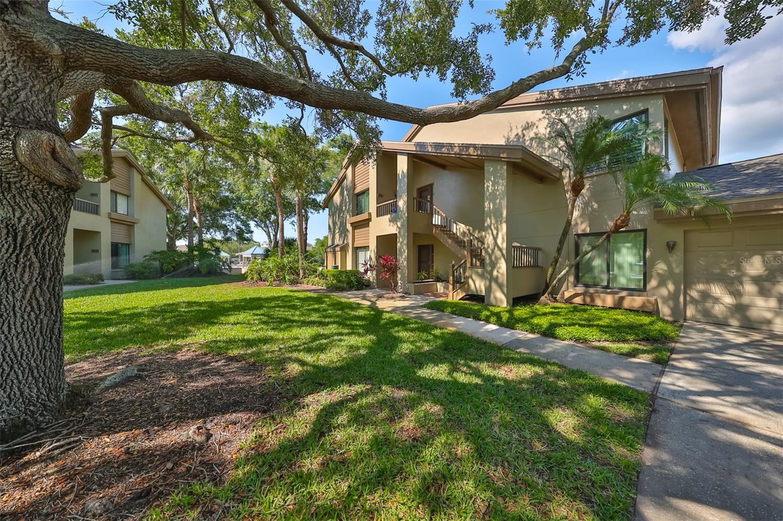 Welcome home to this beautiful 3 bedroom 2 bath condo tucked away in the charming community of Landmark Oaks! Ever want the luxury of sipping morning coffee over looking water, but didn't want the price tag or insurance cost of beach front? Well, you found it! This home has a beautiful VIEW of the COMMUNITY POND & POOL Truly Florida living! The home features a WOOD BURNING FIRE PLACE, hardwood floors throughout, VAULTED CEILINGS, laundry room, and a formal dining room. This split floor plan is perfect for those wanting to entertain guest, creating a home office or kids bedroom. The primary bedroom has plenty of storage with a WALK IN CLOSET and double vanity! Additionally, the home features an oversized 1 car garage just a few steps away equipped with a CAR CHARGER. HOA DUES INCLUDE BASIC CABLE, WATER, SEWER, TRASH AND EXTERIOR!