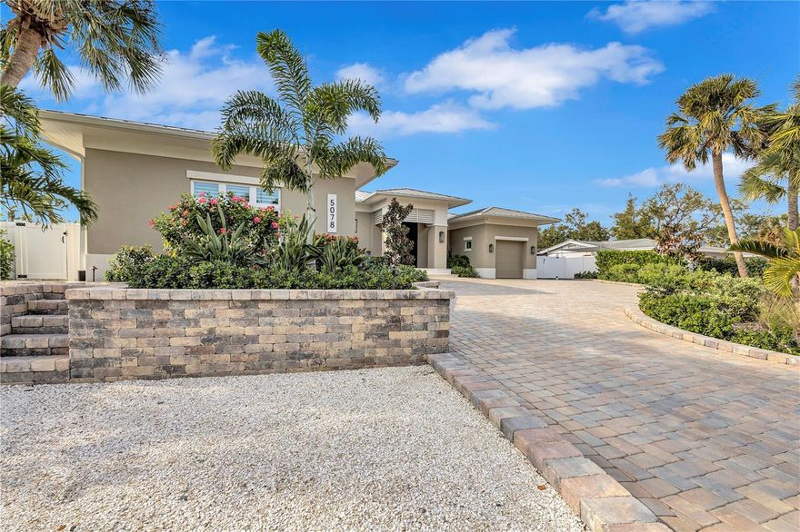 * Please note, property is pending but cannot be marked pending in MLS until MLS admin are available on Monday, 1/19/26.

Completed in 2024, this custom one-story canal-front residence in the sought-after Sara Sands neighborhood offers a seamless blend of modern coastal design and effortless island living. Ideally located just minutes from Siesta Key Village, you’re close to boutique shopping, top restaurants, coffee shops, popular wine bar, and lively evening entertainment—while enjoying excellent boating water with quick 10–15 minute access to the Intracoastal Waterway.

The home welcomes you with striking curb appeal, featuring a wide paver driveway, lush tropical landscaping, and a covered entry leading to an impressive wood front door. Inside, the open, airy floor plan is designed to maximize indoor-outdoor living. The main living space flows beautifully into the outdoors, highlighted by a dramatic covered lanai with a rich wood-plank ceiling, recessed lighting, and modern ceiling fans—creating a resort-style atmosphere year-round.

The gourmet chef’s kitchen is both functional and elegant, showcasing custom wood cabinetry, quartz countertops, premium appliances, and a dedicated beverage bar ideal for entertaining. Large sliding glass doors open fully to the expansive covered patio, creating a true extension of the living space.

This thoughtfully designed home offers four bedrooms and four bathrooms, providing privacy and comfort for family and guests alike. Each space is finished with clean lines, high ceilings, and quality craftsmanship throughout.

Outdoors is where this property truly shines. The large covered patio deck includes multiple seating and dining areas, a fully equipped outdoor kitchen, and overlooks a resort-style pool with sun shelf, all framed by tropical landscaping and tranquil canal views. A covered boathouse with 10,000 lb lift, charming gazebo, and fenced yard complete this exceptional waterfront setting—perfect for boating days, sunset gatherings, and relaxed island evenings.

This is a rare opportunity to own a nearly new canal-front home in one of Siesta Key’s most desirable neighborhoods—offering luxury, lifestyle, and location in perfect harmony.