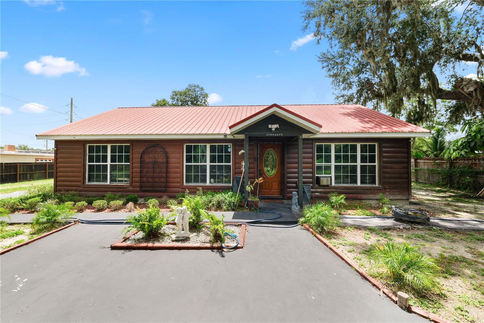 Embrace serene living in this charming 3-bedroom, 2-bathroom home, designed to capture the rustic appeal of a log cabin with the ease of newer construction. Situated at the end of a quiet dead-end street, the front of the home opens directly onto protected conservation land, providing peaceful, unobstructed views and a natural buffer for added privacy. Inside, the open floor plan features vaulted ceilings, warm wood accents, creating a cozy yet spacious atmosphere. The primary suite includes a private bathroom, while two additional bedrooms provide versatility for family, guests, or a home office. This home offers a unique combination of rustic charm, modern comfort, and a beautiful natural setting—perfect for those seeking peace and privacy. Outside, there is a large storage shed perfect for all workshop. The wide extra-long driveway is a rare find—ideal for parking trailers, boats, or RVs with ease. Whether you’re an outdoor enthusiast or just appreciate the added space, this feature offers flexibility and convenience you won’t often find. This home is the perfect place to relax, entertain, or simply enjoy country living. Schedule your private showing today!