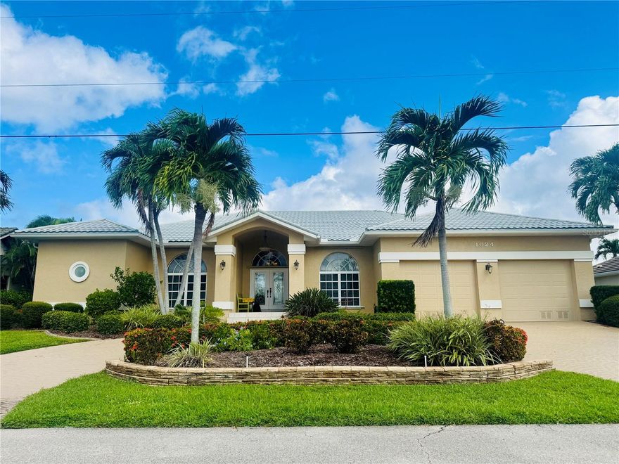 Coastal Luxury Meets Everyday Comfort! 

This stunning 3,013 sq. ft. waterfront retreat is more than just a home—it’s your own private oasis! Perfectly positioned just minutes to open water, it offers the best of Florida living with a 35-foot heated pool, spa, outdoor summer kitchen, and an 80-foot dock with boat lift.

Step inside to discover a thoughtfully updated and redesigned interior. This kitchen is a chef’s dream, featuring rich wood cabinetry with abundant storage, granite counters, center island, sleek new appliances, and a double-door pantry. A casual breakfast nook with pool views and a generous breakfast bar seamlessly flow into the expansive family room—complete with gleaming hardwood floors and walls of windows that fill the space with natural light.

Enjoy both formal and casual living options. A gracious living room opens to the lanai, while the formal dining room sets the stage for memorable dinners. Need extra space? The versatile office/man cave provides just the right spot to work—or unwind.

The primary suite is a retreat of its own with hardwood floors, direct lanai access, two walk-in closets, and a spa-like bath featuring a dual vanity and Roman-style glass block walk-in shower. Two spacious guest bedrooms, each with walk-in closets, and a completely updated guest bath (with pool access!) ensure everyone feels right at home.

Practicality meets style with a huge laundry room (Washer and Dryer 2 years old), half bath, and an oversized 27x20 garage offering exceptional storage.

Step outside and you’ll see why this home was designed for entertaining. The expansive lanai has plenty of lounging space, a fully equipped summer kitchen, and of course—the sparkling heated pool (Heater replaced 4 years ago) and relaxing spa. With a 100-foot seawall and quick access to Charlotte Harbor, it’s a boater’s dream come true. 

This home truly checks every box—space, style, updates, and location. Don’t just dream about waterfront living—make it yours!