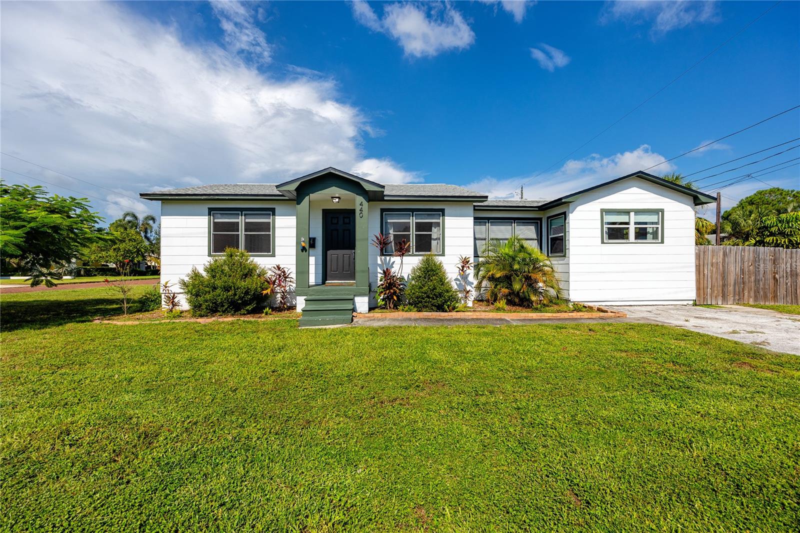 Rare find in the heart of St. Petersburg’s Russell Park neighborhood! This 3-bedroom, 2-bathroom single-family home was fully renovated in 2022, offering a perfect balance of modern comfort, versatile functionality, and timeless mid-century character. With an oversized corner lot, ADU potential, and proximity to both downtown St. Pete and the Gulf beaches, this home is ideal for buyers seeking a turnkey residence with long-term value.
Inside, the 1,170 sq. ft. open floor plan is bright and inviting, with large windows, fresh paint, and chic tropical accent murals enhancing the home’s boho-meets-mid-century aesthetic. Low-maintenance luxury vinyl plank flooring, updated ceiling fans, and thoughtful details create a space that’s both stylish and functional.
The modern kitchen serves as the centerpiece of the home, showcasing solid wood cabinets, quartz countertops, a central island with breakfast bar and storage, and newer Frigidaire stainless steel appliances. Whether for casual meals or entertaining, this space is designed to impress.
The primary suite includes a spacious closet with built ins, a sleek ensuite bath with a custom-tiled walk-in shower, and private access to the backyard. Two additional bedrooms share a fully updated bath with a tub/shower combo and modern fixtures. The third bedroom’s flex space can easily function as a home office, studio, or oversized walk-in closet with vanity. A charming barn-door laundry closet in the dining room with a full-size ThinQ washer and dryer completes the interior.
Set on an oversized 54x104 ft. corner lot, the outdoor space is fully fenced and ready to enjoy. Features include shaded seating areas, raised garden beds, mature tropical landscaping, and a large Tuff shed for extra storage. With alley access and NT-2 zoning, the property offers future ADU potential, adding flexibility for guest housing, multigenerational living, or supplemental rental income.
Practical updates provide peace of mind include a new roof (2022), new A/C system (2021), and the full remodel make this home truly move-in ready. Best of all, it’s located outside of a flood zone and has no HOA restrictions, giving you freedom and long-term security.
Just minutes from downtown St. Petersburg, the Grand Central District, I-275, and Gulf Coast beaches, this bungalow delivers the best of city convenience and coastal lifestyle. Whether you’re a first-time homebuyer, downsizer, or investor seeking a property with both charm and future upside, this home checks every box.
