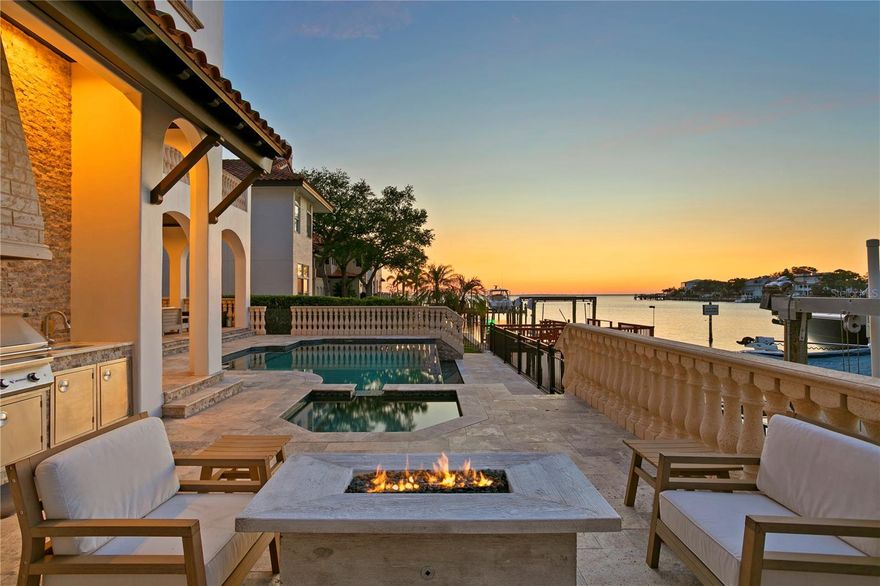 ***SOLD*** Welcome to your dream custom waterfront home offering the best of both worlds - open water views of Tampa Bay and a protected dock with two boat lifts. This one-of-a-kind property impresses from the start with its grand custom iron gates leading you into a tranquil courtyard area full of natural light and a serene fountain. Step inside and be captivated by the luxurious and fine details throughout the home. The formal living and dining rooms, whose gorgeously stained tongue and groove ceilings, feature elegant French doors that open onto covered porches, seamlessly blending indoor and outdoor living. Enjoy prime entertainment on the large lanai, watch the sunset to relax in the evening, or unwind in the pool or spa after a long day - all while enjoying the stunning open water views as you sit by the fire pit. Inside, the main kitchen offers top-of-the-line appliances, two large islands, two sinks, a walk-in pantry, and the luxury of a temperature-controlled wine cellar just down the hall. Each of the five bedrooms in the home features its own en-suite bathroom for ultimate comfort and privacy. The first floor features a full guest suite, an office that could also be used as a 6th bedroom, and a convenient spacious half bath for guests. Upstairs, the newly renovated master suite offers a luxurious retreat with large windows showcasing the open water views, a stunning accent wall, a custom-designed walk-in closet, a wet bar with a mini fridge, and an exquisite en-suite bathroom with a double walk-in shower. The suite opens directly onto a private second-floor balcony with a covered porch, where you can enjoy the best of the Florida lifestyle overlooking the water. The second floor also features three additional bedrooms, each with its own en-suite bathroom & walk-in closet, an in-home gym with newly installed flooring, and a laundry room with plenty of storage space. Experience the best of Tampa living in the coveted Plant High School District, located just minutes from Downtown Tampa, the Tampa Riverwalk, sports venues, Tampa International Airport, and the exceptional Gulf beaches!