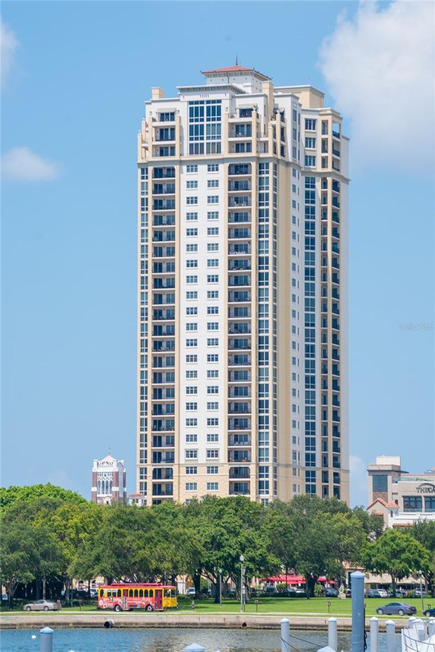 LUXURY LIVING WITH SWEEPING WATER AND CITY VIEWS IN THE HEART OF DOWNTOWN ST. PETERSBURG
Experience refined urban living at Parkshore Plaza, one of downtown St. Petersburg’s most distinguished luxury towers. This prestigious residence offers breathtaking, front-row views of Tampa Bay, the vibrant downtown skyline, and the surrounding waterfront parks that frame the city’s iconic landscape.
The expansive covered wraparound balcony, accessible from three separate interior points, serves as an extraordinary outdoor living space where the views stretch from east to west, creating a constantly evolving panorama of sparkling bay waters, passing boats, glowing sunsets, and the distant silhouette of the Sunshine Skyway Bridge. It is the perfect setting for morning coffee, evening cocktails, or simply taking in the beauty of St. Petersburg’s waterfront lifestyle.
Inside, this elegant 3-bedroom, 3.5-bath residence spans 2,767 square feet of thoughtfully designed living space, ideal for both everyday comfort and gracious entertaining.
Upon exiting the elevator, you are welcomed into your own private entry lobby, a coveted feature that enhances both privacy and security.
The interior showcases newly installed wood flooring, bringing warmth and sophistication to the home while complementing the timeless architectural finishes. The foyer opens into a spacious great room where walls of glass frame spectacular views of Tampa Bay and the surrounding parks.
Every window is appointed with either high-end white plantation shutters or adjustable mesh blinds, allowing natural light to fill the space while maintaining comfort and privacy.
The well-appointed kitchen blends functionality with style, featuring tropic brown granite countertops, a gas cooktop, smart refrigerator, rollout pantry shelving, abundant cabinetry, and recessed lighting. An inviting eat-in kitchen vestibule and convenient dry bar create additional space for hosting and entertaining.
The expansive primary suite provides a private retreat with two oversized walk-in closets and a spacious ensuite bath highlighted by dual granite-topped vanities and a large soaking tub. The additional bedrooms are equally well proportioned, including a second bedroom with its own generous walk-in closet.
This residence also includes two secure parking spaces, along with a large private storage unit.
Residents of Parkshore Plaza enjoy an exceptional suite of amenities, including 24-hour concierge service, on-site management, heated pool and spa, fitness center with massage room, billiards room, business center, library, and an elegant social room with full kitchen, bar, formal dining space, and private balcony. The building’s lavish fountains, marble finishes, and Mediterranean-inspired architecture create a sense of timeless grandeur throughout.
Perfectly positioned in the epicenter of downtown St. Petersburg, Parkshore Plaza places you just steps from waterfront parks, world-class dining, museums, theaters, boutiques, and the Pinellas Trail, a beloved 50-mile biking and walking path. With its vibrant arts culture, stunning waterfront, and walkable downtown lifestyle, St. Petersburg continues to be one of Florida’s most desirable places to call home.
