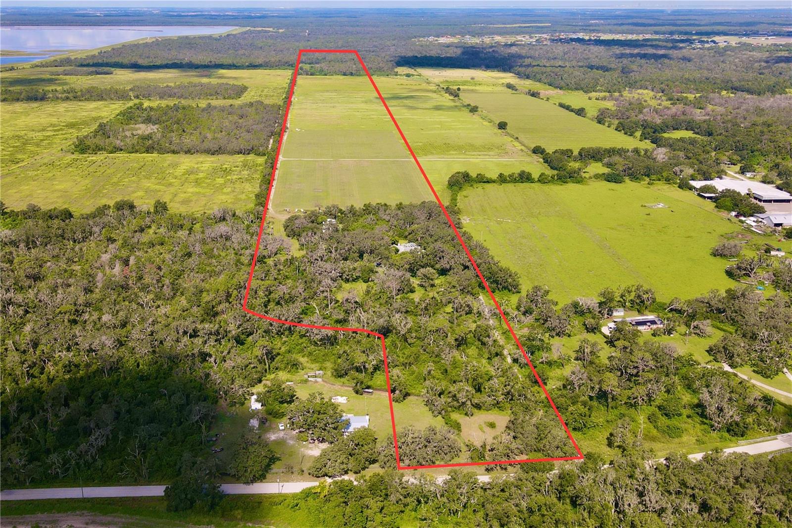 Saffold Farms offers approximately 82 acres in northern Manatee County, located in the growing community of Parrish. The property includes 50 acres of farmland, with the remainder in native woods. The Little Manatee River runs along the western edge of the property, and a creek crosses the land near Saffold Road. Soils are primarily Myakka, with areas of Cassia and Zolfo fine sands, suitable for a range of agricultural uses.
Improvements include a 3,314 SF home (4 bed / 5 bath) built in 1991, an equipment barn, a pole barn, and a storage shed. The property has two 10” wells and an active SWFWMD Water Use Permit.
The property is zoned A (General Agriculture) with a future land use of AG-R. The surrounding area consists of farms and conservation land.
The property is located at 14201 Saffold Road in Parrish. Saffold Road is the Manatee County continuation of County Road 579 - connecting State Road 62 in Manatee County to State Road 674 in Hillsborough County.
The property is five minutes north of State Road 62, eight minutes south of State Road 674, ten minutes east of US-301, and 20 minutes from I-75. With its close proximity to major roads, it is commutable to Wimauma (10 minutes), Fish Hawk (30 minutes), Bradenton (40 minutes), Tampa (45 minutes), Sarasota (50 minutes), and Tampa International Airport (55 minutes). Additionally, local shopping, medical, and schools are within a 15 minute drive.