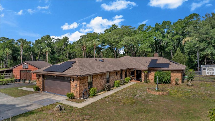 Nestled down a private drive, this unique 4-bedroom, 3-bath property offers peace, privacy, and endless possibilities on 2.5 beautiful acres. Surrounded by nature and thoughtfully designed outdoor spaces, this property is ideal for those seeking room to grow, garden, create, or simply enjoy a quieter lifestyle.

The home features spacious living areas, skylights, and a fireplace that add warmth and character throughout. The layout offers comfort and flexibility, accommodating a large family with plenty of space both inside and out.

Step outside to a beautiful screened pool and sitting area designed for relaxing and entertaining. The expansive outdoor space backs up to a neighboring property with horses, adding to the serene country feel.

The land offers incredible flexibility for gardening, hobby farming, or creating a private retreat. The property includes a versatile accessory structure/flex space along with a separate storage shed perfect for equipment, tools, or hobby farm use. The grounds are filled with mature landscaping and a variety of fruit plants, including peach, fig, blueberry, raspberry, moringa, and watermelon.

A truly special and hard-to-find property full of charm, tranquility, and endless potential.