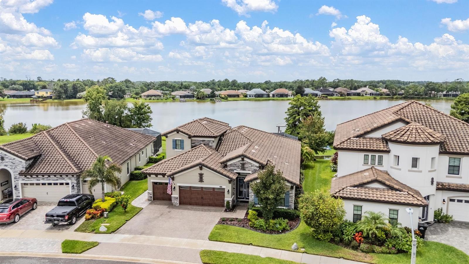 Experience Unmatched Lakefront Luxury in Pristine Lake Preserve!
Welcome to this exceptional LAKE FRONT 4-bedroom, 4-bathroom POOL home with a private office and bonus room, located in the exclusive gated community of Pristine Lake Preserve in Land O’ Lakes. Built by WestBay Homes, this over 3,000 sq ft residence is thoughtfully designed to elevate your lifestyle—combining elegant interior spaces, luxurious outdoor living, and direct access to the tranquil waters of Curve Lake.
From the moment you arrive, the pavered driveway and sidewalk, mature landscaping, and serene lake views set the tone for what awaits inside. Step through the grand entry into a light-filled, open-concept living space with wood-look plank tile flooring, soaring trey ceilings, and custom finishes throughout.
The chef’s kitchen is both beautiful and functional, featuring granite countertops, tile backsplash, top of the line stainless steel appliances, gas range, a large center island and eating space, a built in desk to get your meal planning complete for the week and generous storage. Plantation shutters offer both privacy and style throughout the home.
The primary suite is a serene retreat overlooking the pool and lake, complete with a custom walk-in closet system, separate vanities and a make up desk make getting ready for your day a breeze, a rain shower head, and a spacious walk-in shower.
Off the main hallway double doors lead to the private office, ideal for working from home with quiet focus.
Bedroom 2 is located at the front of the home and features a built-in closet, plantation shutters, and a full bathroom just outside the room—perfect for guests. Bedroom 3 sits in the mid-section of the home, also with a built-in closet and a full bathroom nearby. Upstairs, you'll find Bedroom 4 along with a generous bonus room and full bathroom—ideal for a media space, playroom, or private guest retreat.
The 3-car garage includes custom built-in shelving, offering exceptional storage and organization.
Step outside and embrace true Florida lakefront living. The backyard is an entertainer’s dream with a natural gas-heated saltwater pool and spa, a custom natural stone waterfall, and a panoramic sunbeam screen enclosure offering unobstructed views of the water. The fully equipped outdoor kitchen features granite countertops, Blaze commercial-grade grill, power burner, refrigerator, and stainless steel drawers.
Enjoy evenings by the custom firepit or walk along over 150 feet of TREX decking, seamlessly connecting the lanai to your covered dock with electricity. The deep-water dock is perfect for boating, paddleboarding, fishing, or simply relaxing lakeside with a sunset view.
This one-of-a-kind home offers the perfect blend of luxury, functionality, and lifestyle in one of Land O’ Lakes’ most exclusive gated lakefront communities. IT'S NOT JUST A HOME...BUT A LIFESTYLE!